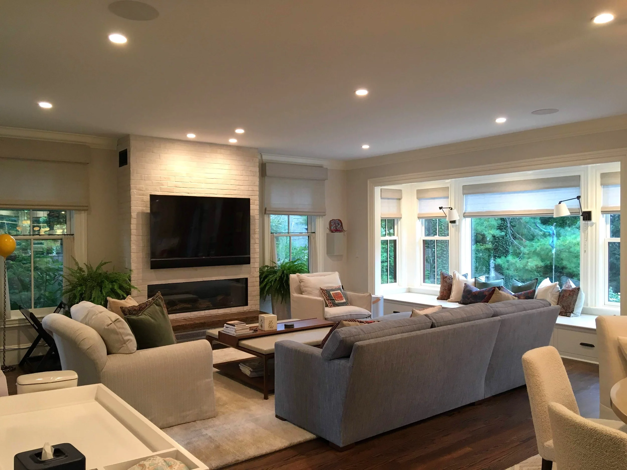 custom light filtering motorized roman shades for luxury family room in Lake Norman NC home