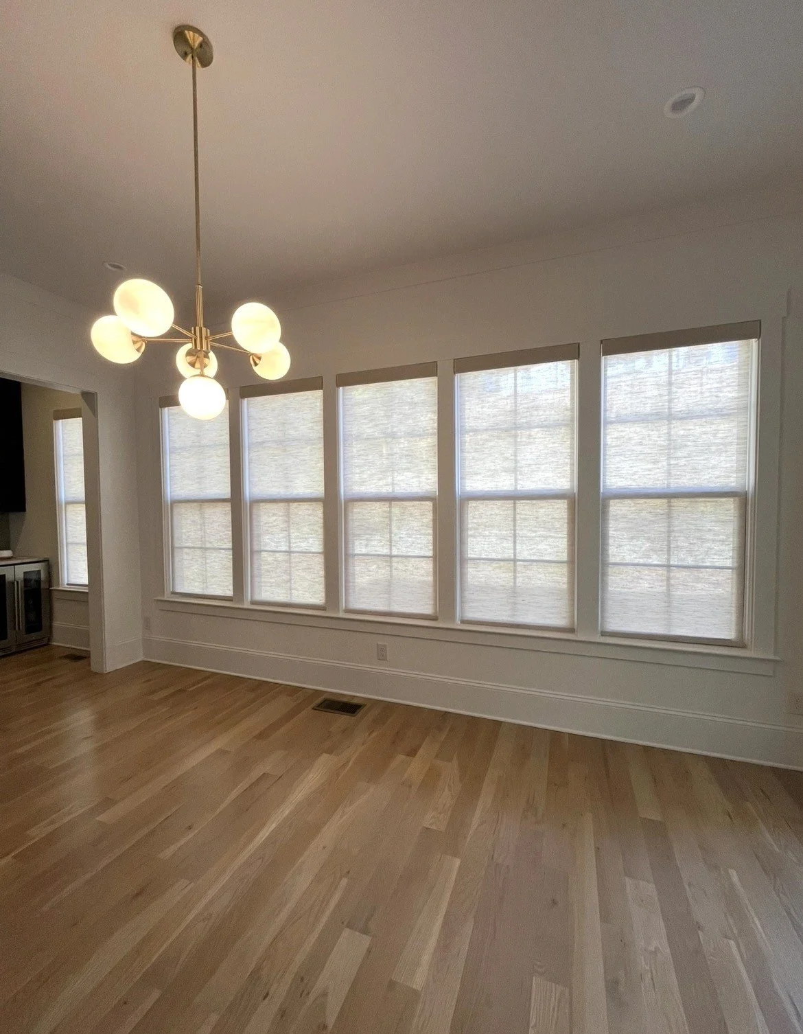 custom light filtering natural roller shades for dining room in Charlotte, NC home