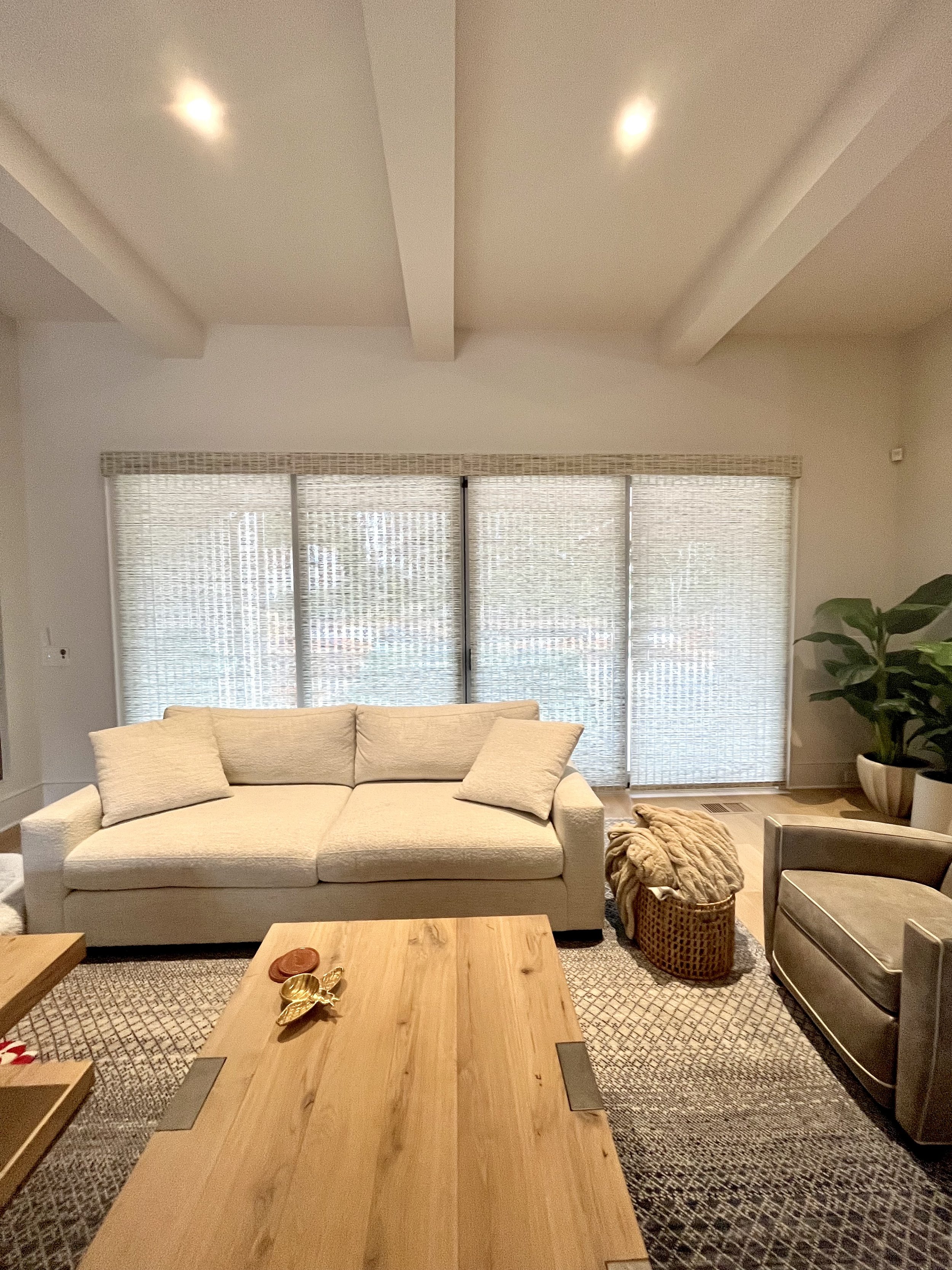 custom motorized natural shades for sliding glass doors in open concept luxury living room in Lake Norman NC home