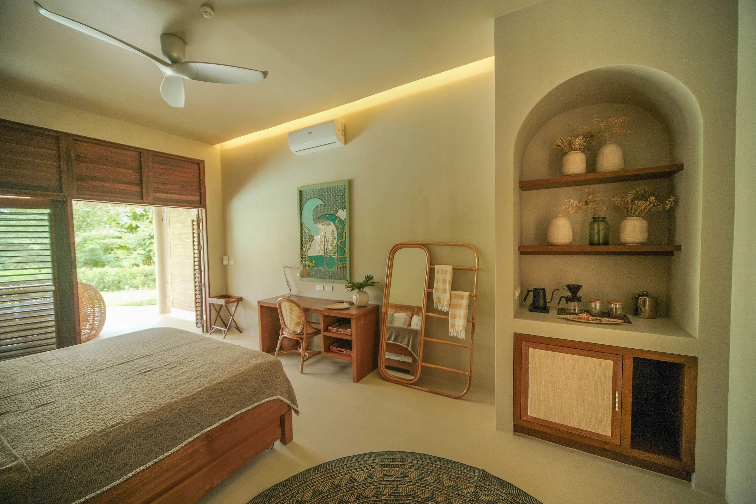 Poolside Suite bedroom at schönhouse Villa Siargao with natural textures, warm lighting and tropical design.