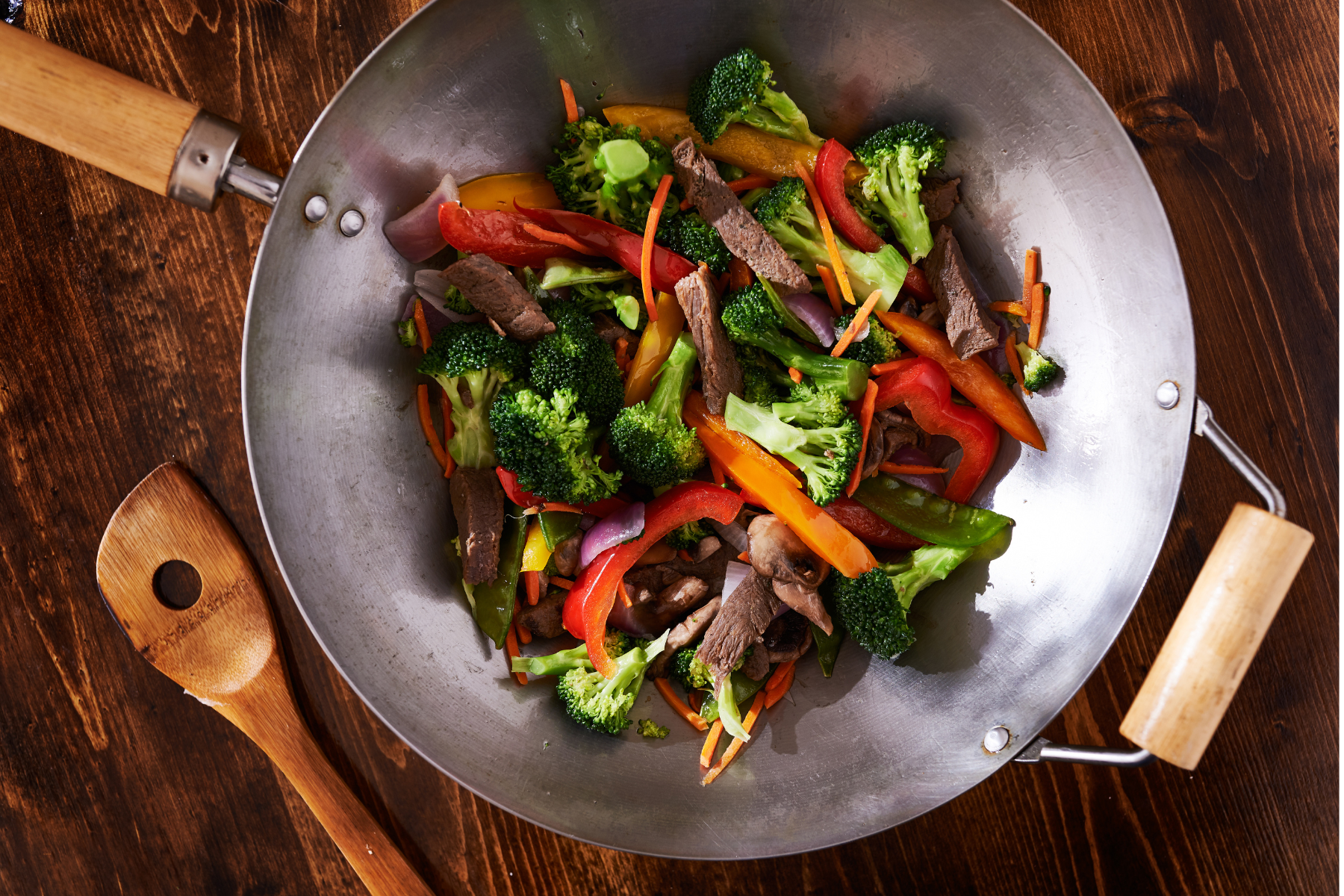 wok pan with stir-fry steak and vegetables