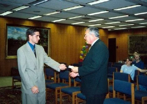 Shane Foley giving Dr. Rex Ball his Bid to become an Honorary Initiate of Lambda Chi Alpha.