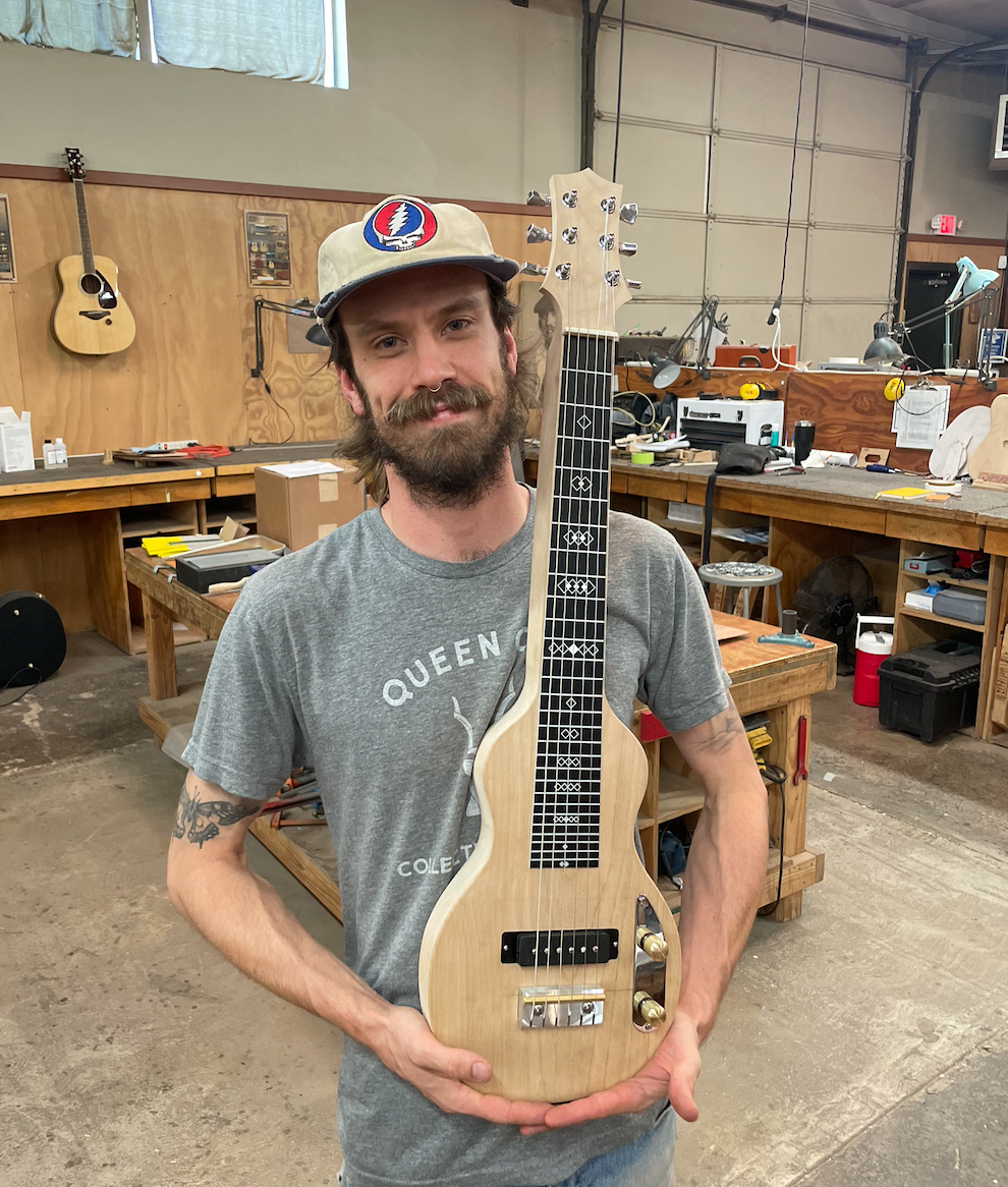 San Francisco luthier Matt Stevens holds a custom-made lap steel guitar in his San Francisco workshop.