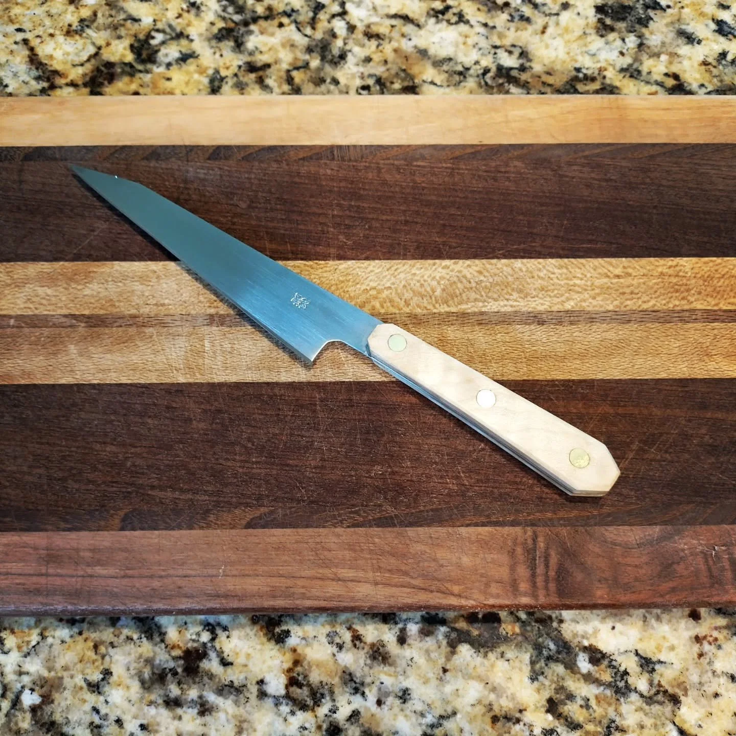 New months bring new pieces! This is my first attempt at a Honesuki-style knife. It has a curly maple handle with brass scale liners and brass pins. With a blade length of 5.25&quot; and an overall length of 9.625&quot;, this knife will excel at ligh