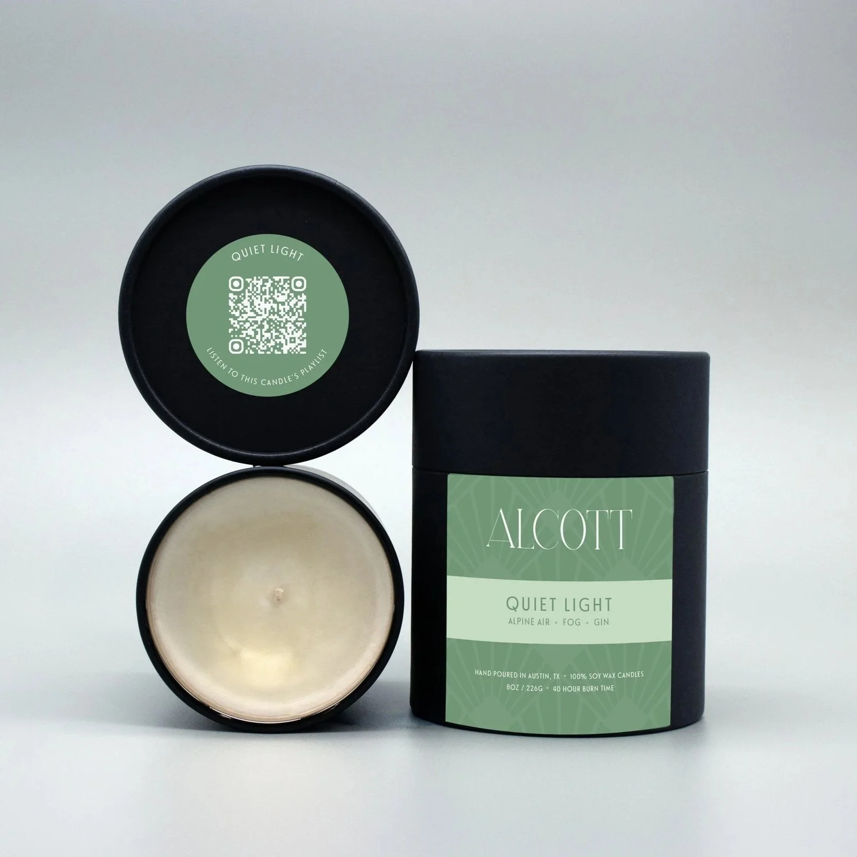 Clean burning candle Quiet Light next to it's plastic-free packaging.