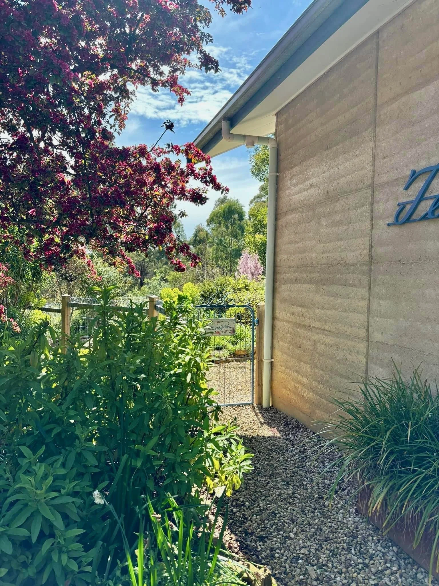 When we designed the fence to Beatrice's Garden we wanted to provide a sweet little path that visitors could look down as they walked toward the front door. 