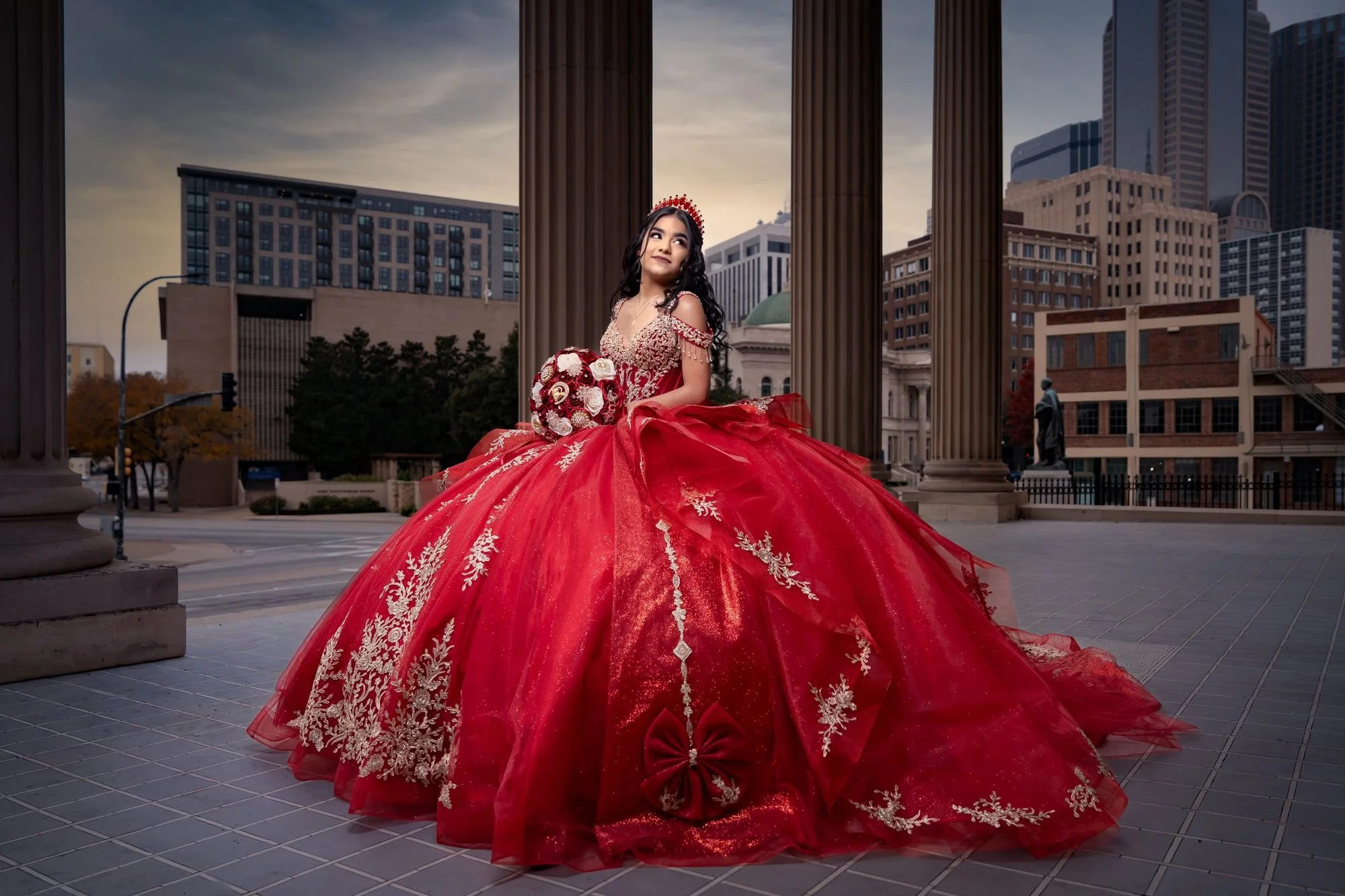 Red quinceañera gown rental in Dallas-Fort Worth, full-length editorial portrait at the Scottish Rite Cathedral with downtown Dallas skyline