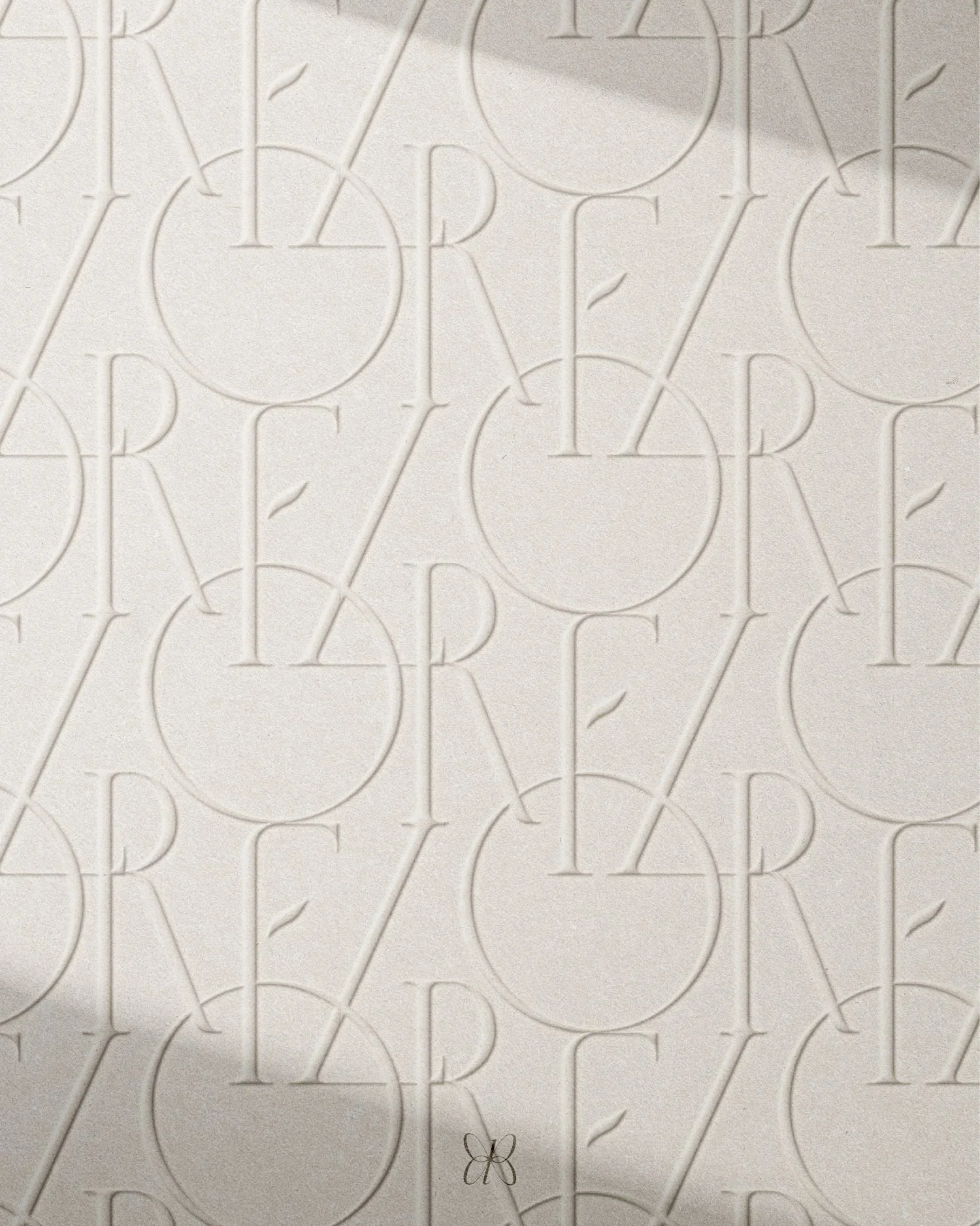 Close-up of a textured, embossed pattern with repeated letters and circles, spelling out 'RARE' and a small butterfly illustration near the bottom.