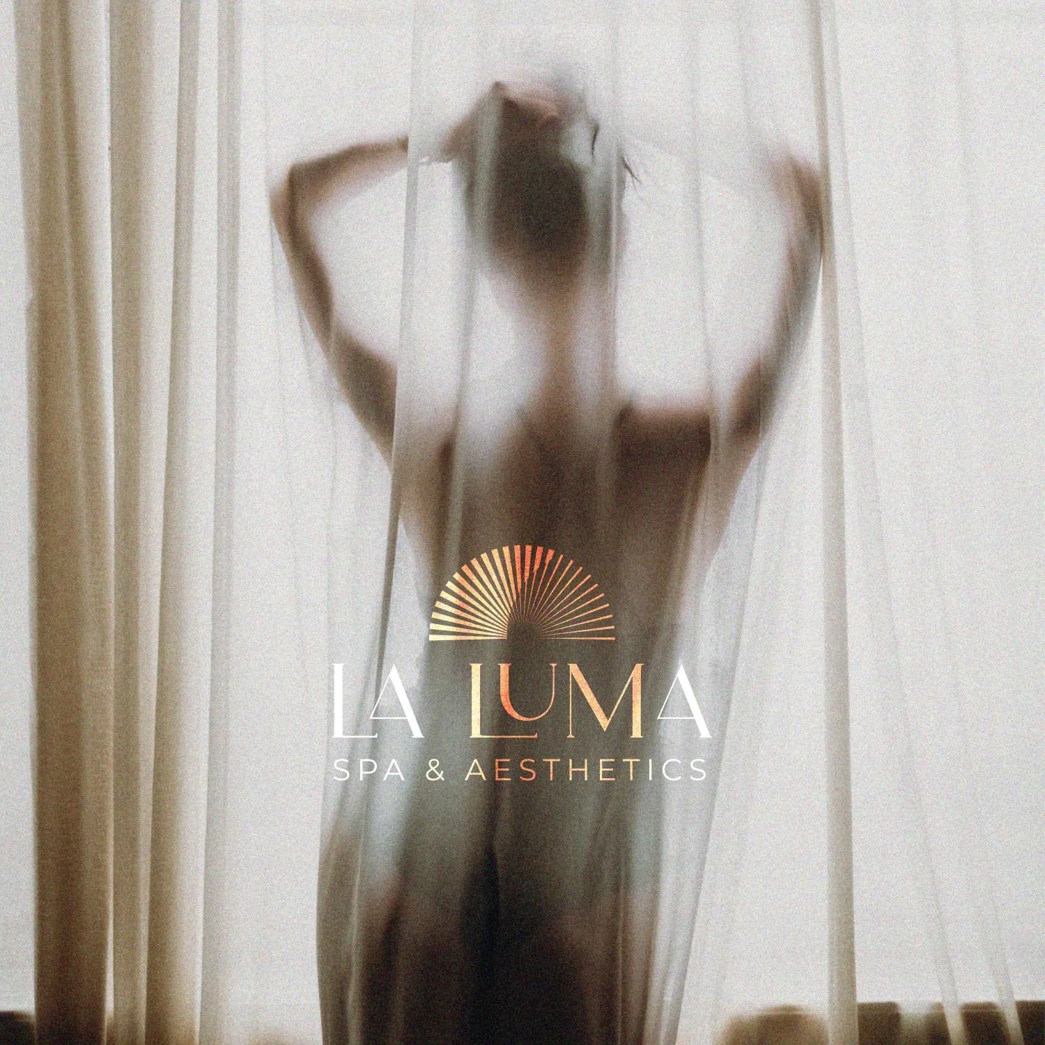 Blurred image of a nude woman behind a sheer curtain, with the logo of La Luna Spa & Aesthetics overlaid.