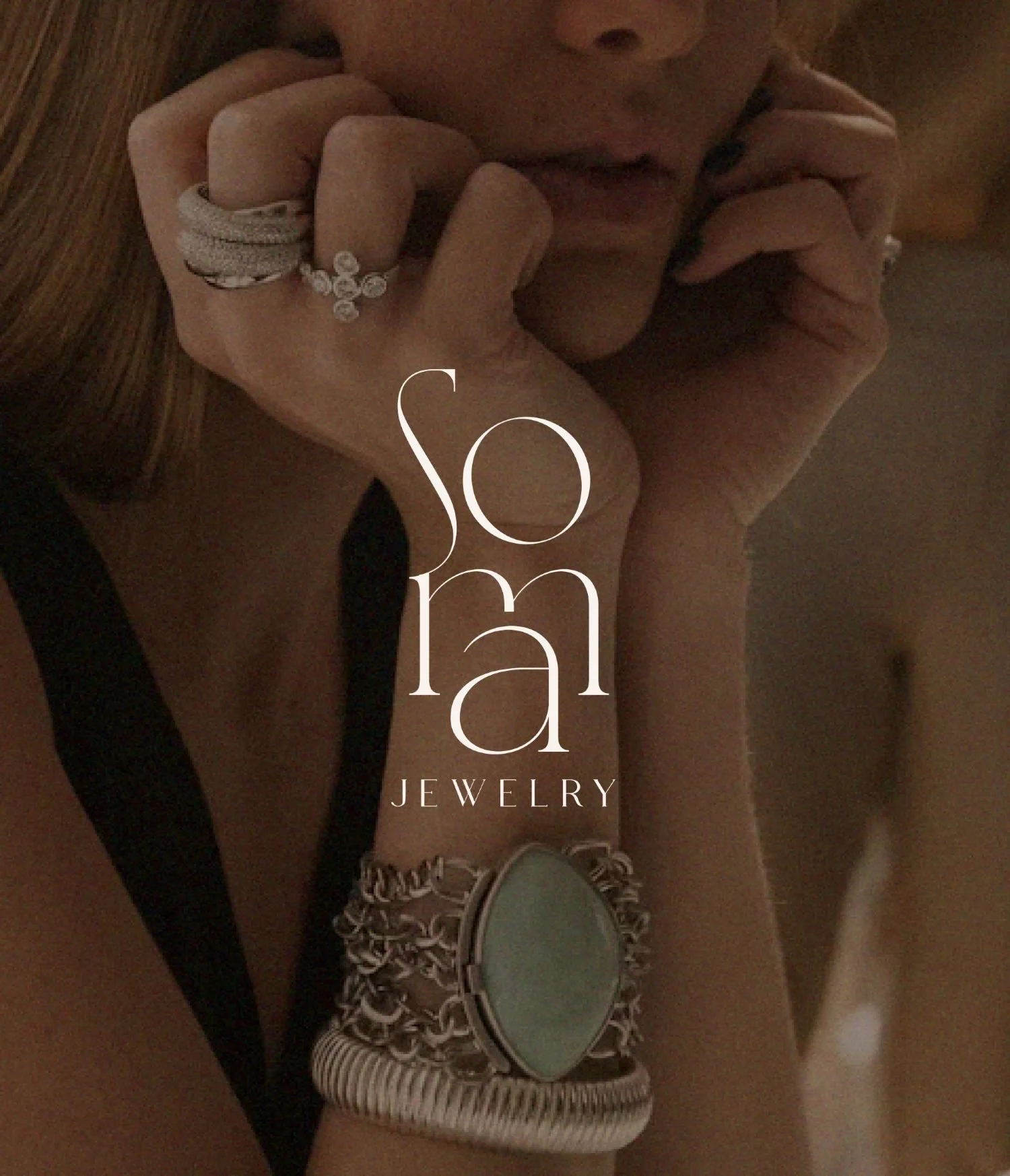 Close-up of woman wearing multiple rings and bracelets, with text overlay reading "Sona Jewelry."