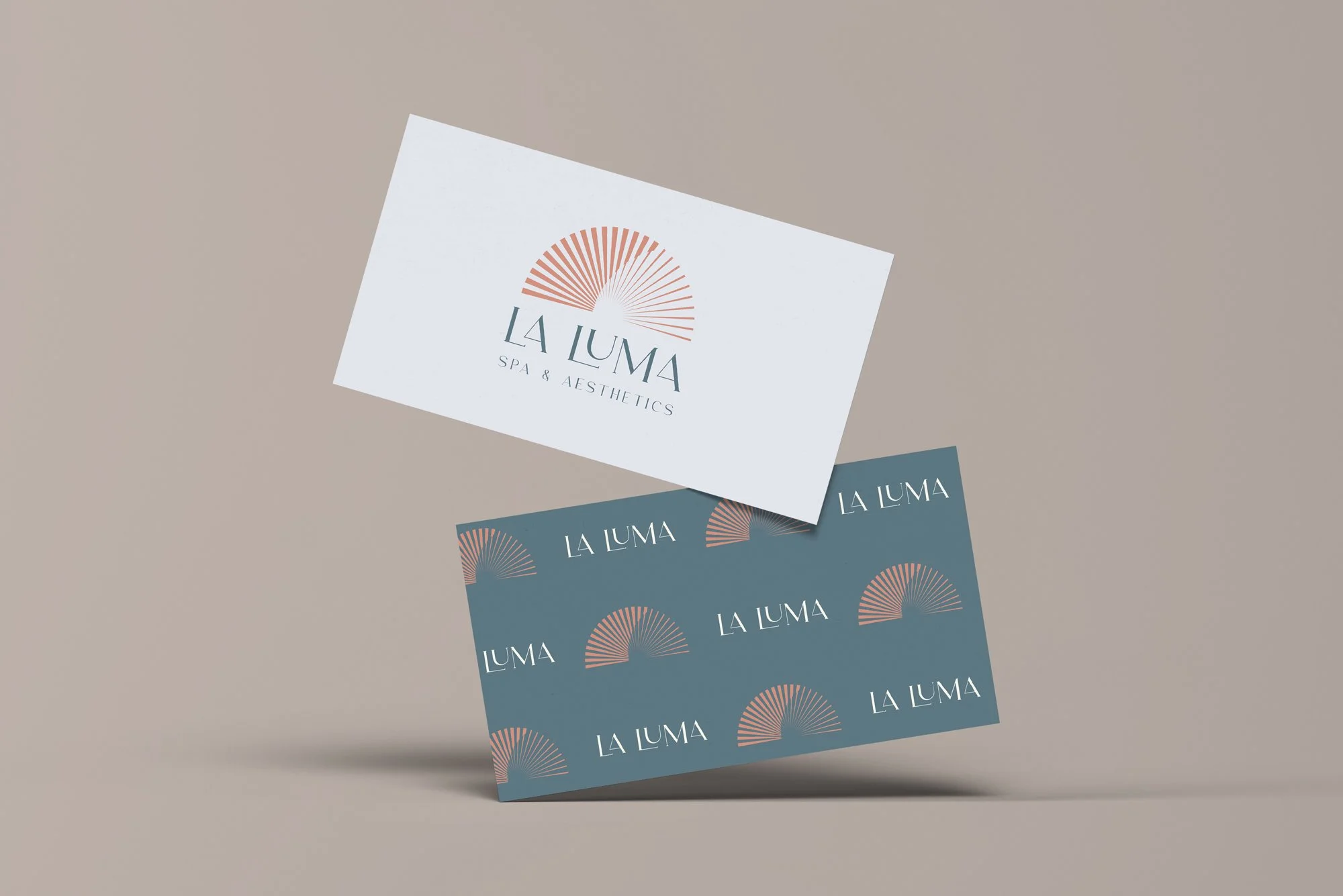 Business cards for La Luma Spa & Aesthetics, featuring a stylized sunburst logo and text, displayed on a neutral background.