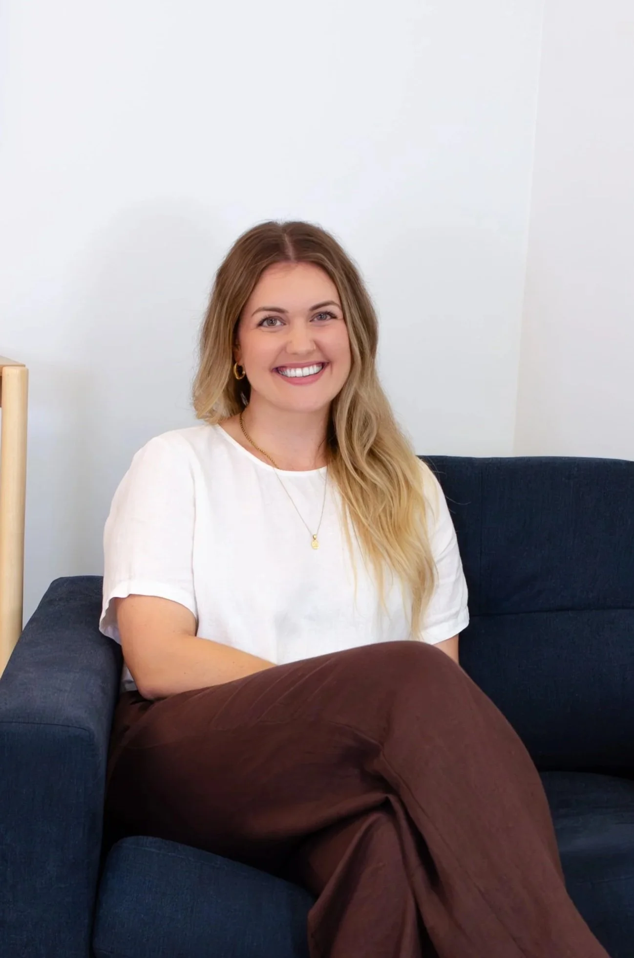 Woman with long brown hair smiling in Beenleigh child and family chiropractic clinic