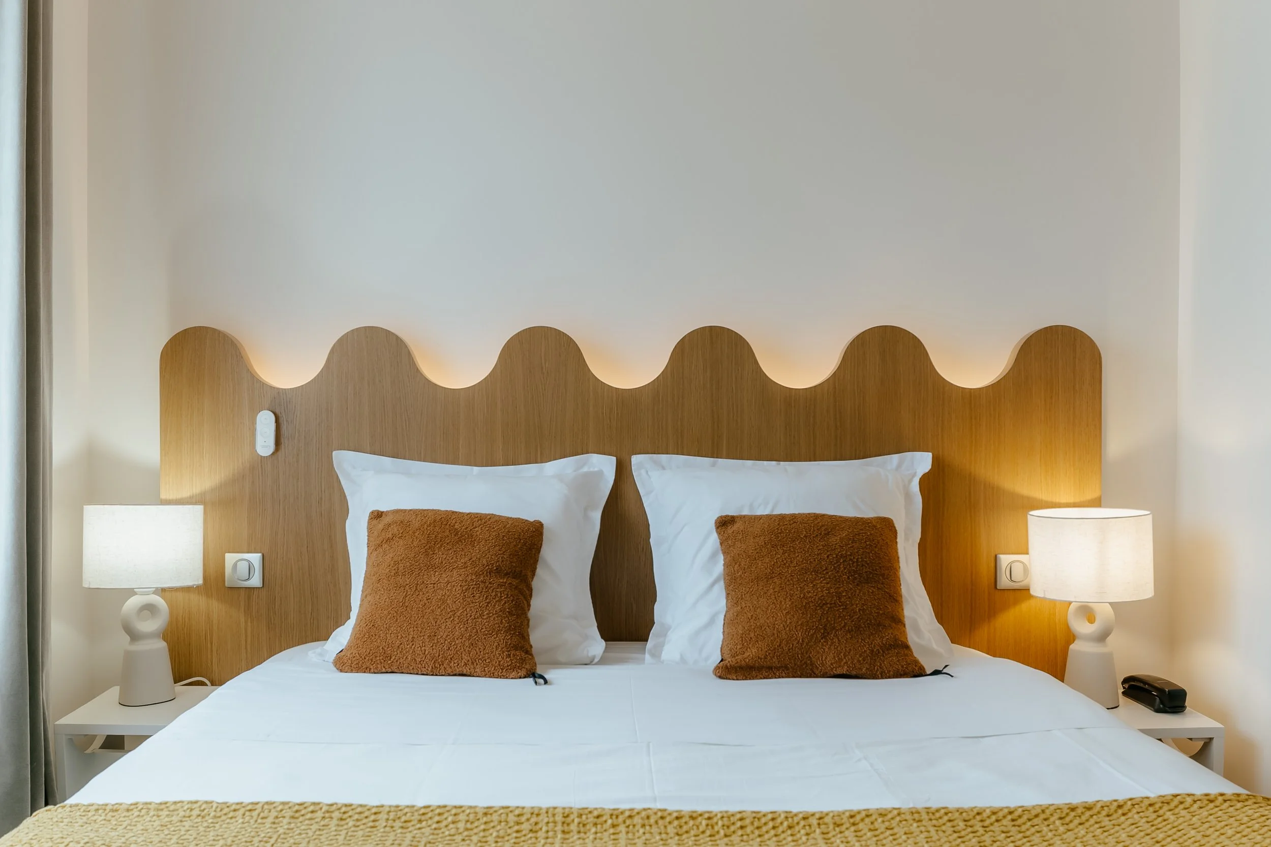 tête de lit sur mesure en bois, représentant les vague de l'océan. Table de chevet et lampe à poser moderne