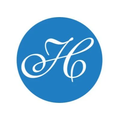 A blue circle with a white, stylized letter 'H' in the center.