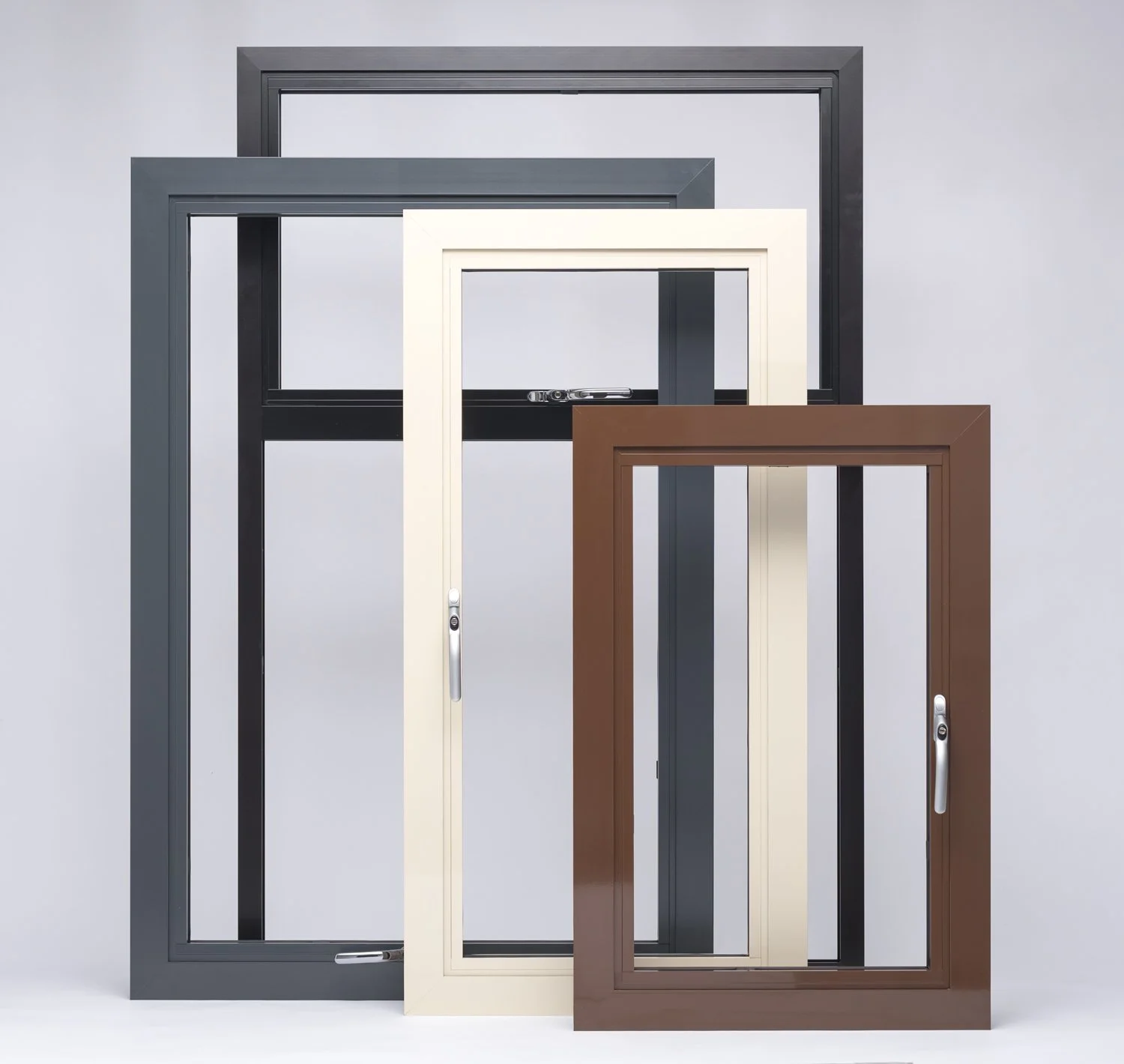 Four empty window frames in various colors and sizes, leaning against a plain light gray wall.