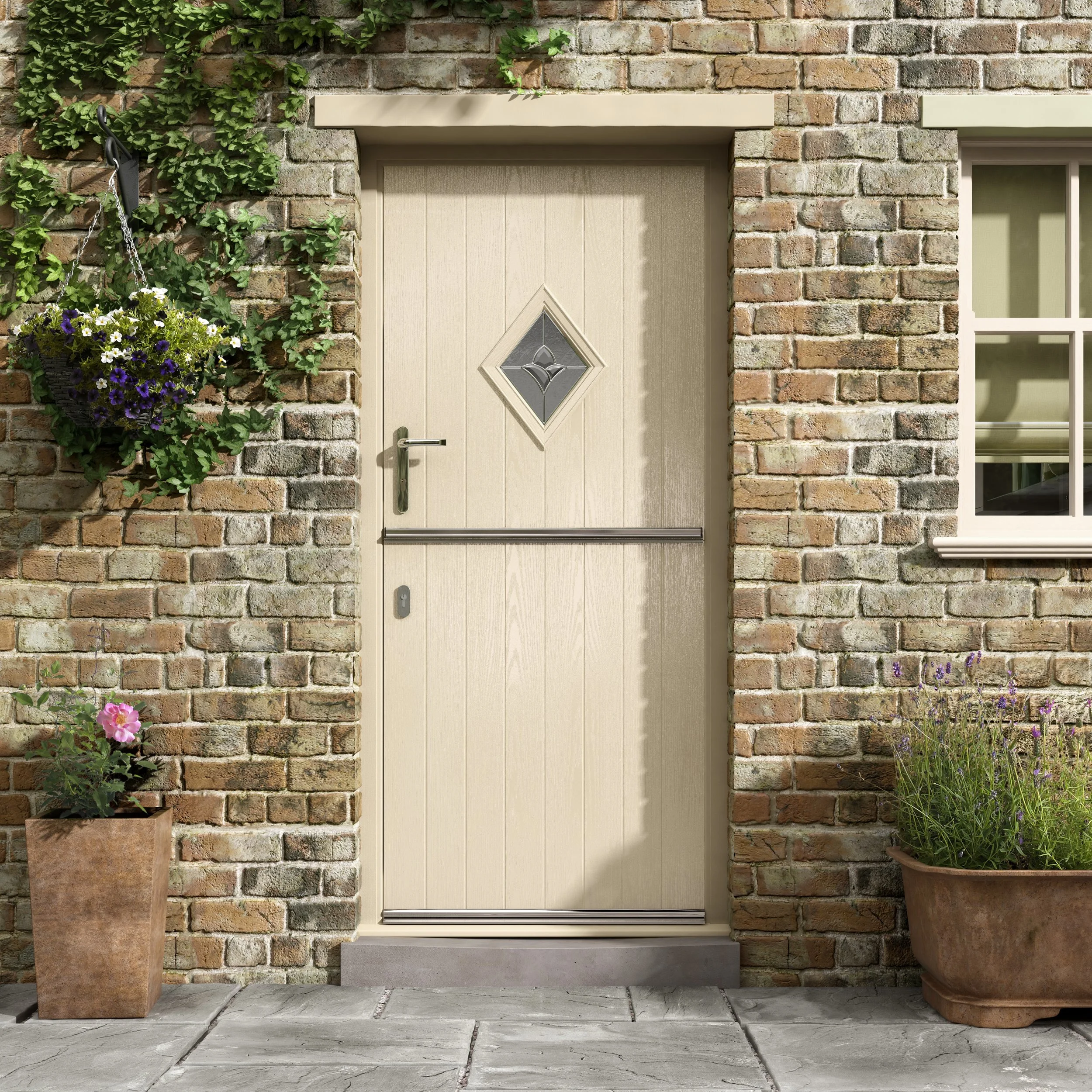 A front door on a brick house with a small diamond-shaped window, a handle, and a door security bar. Two flower pots with plants and flowers are on either side of the door.