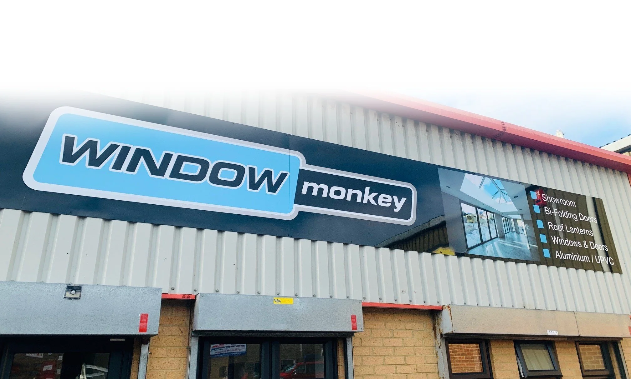 Sign for Window Monkey business with list of services including showroom, bi-folding doors, roof lanterns, windows & doors, aluminum / UPVC