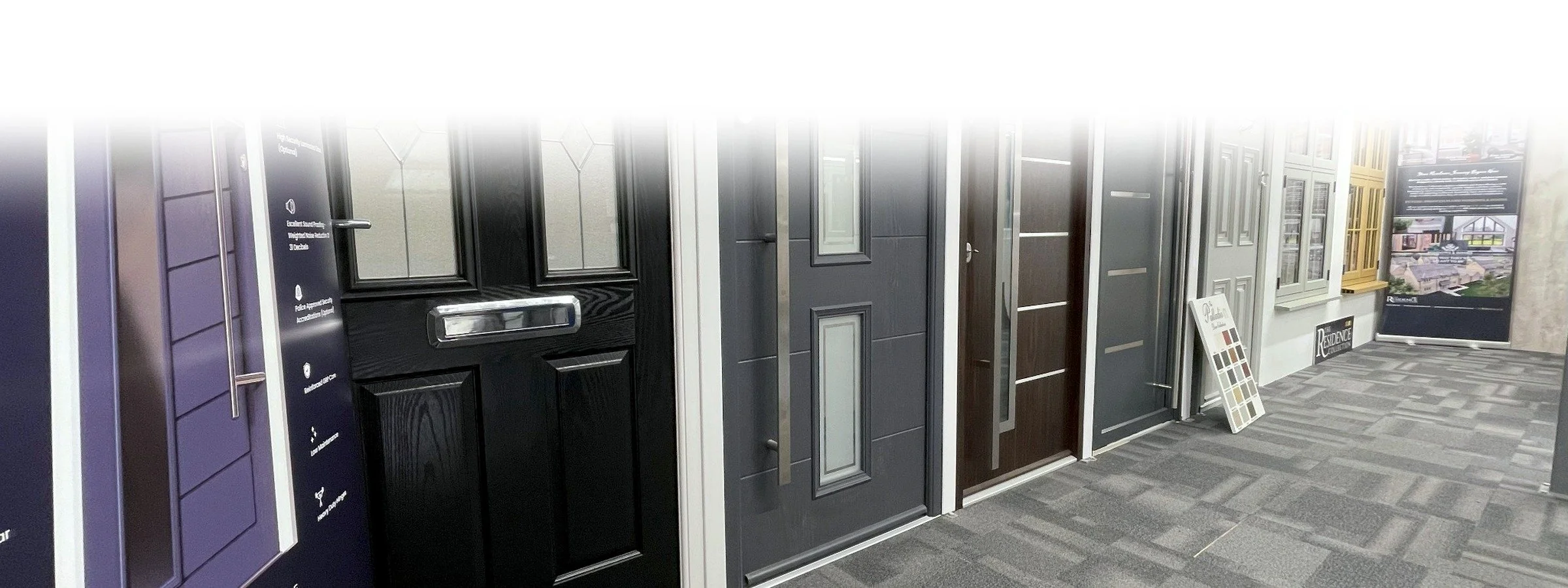Display of various door styles and designs in a showroom.