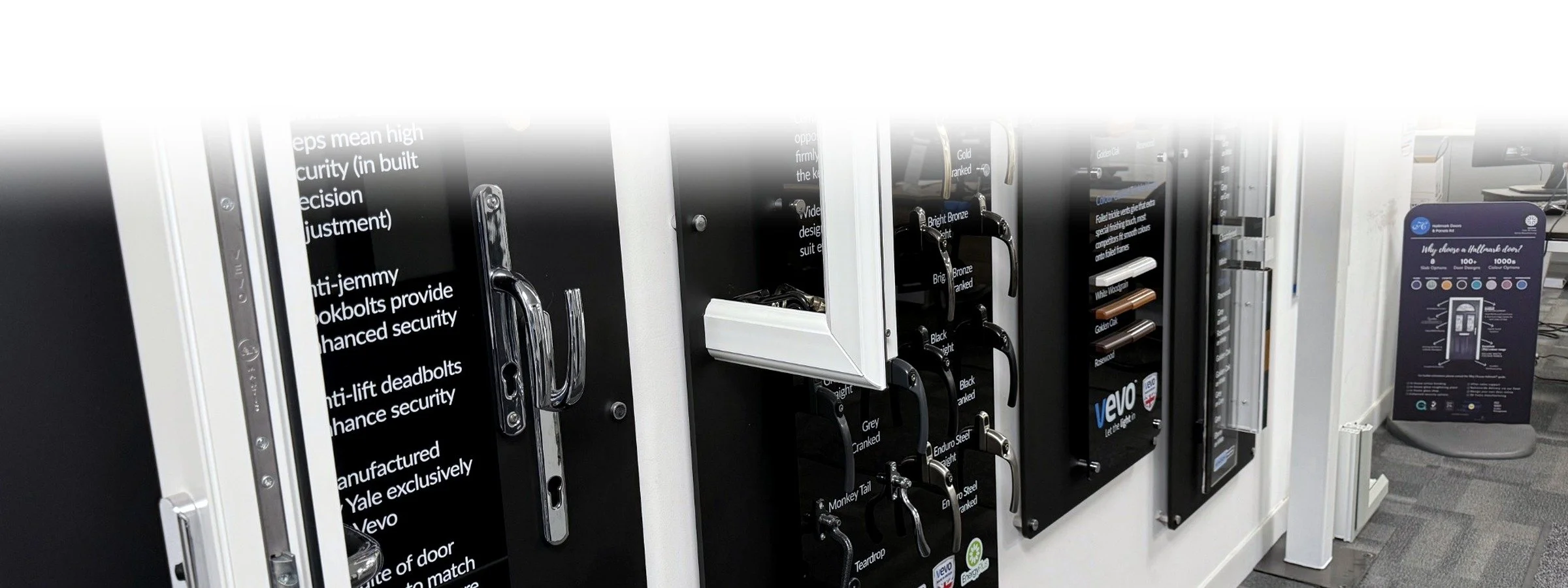 Display of various door handles and lock mechanisms in an exhibit or store setting.