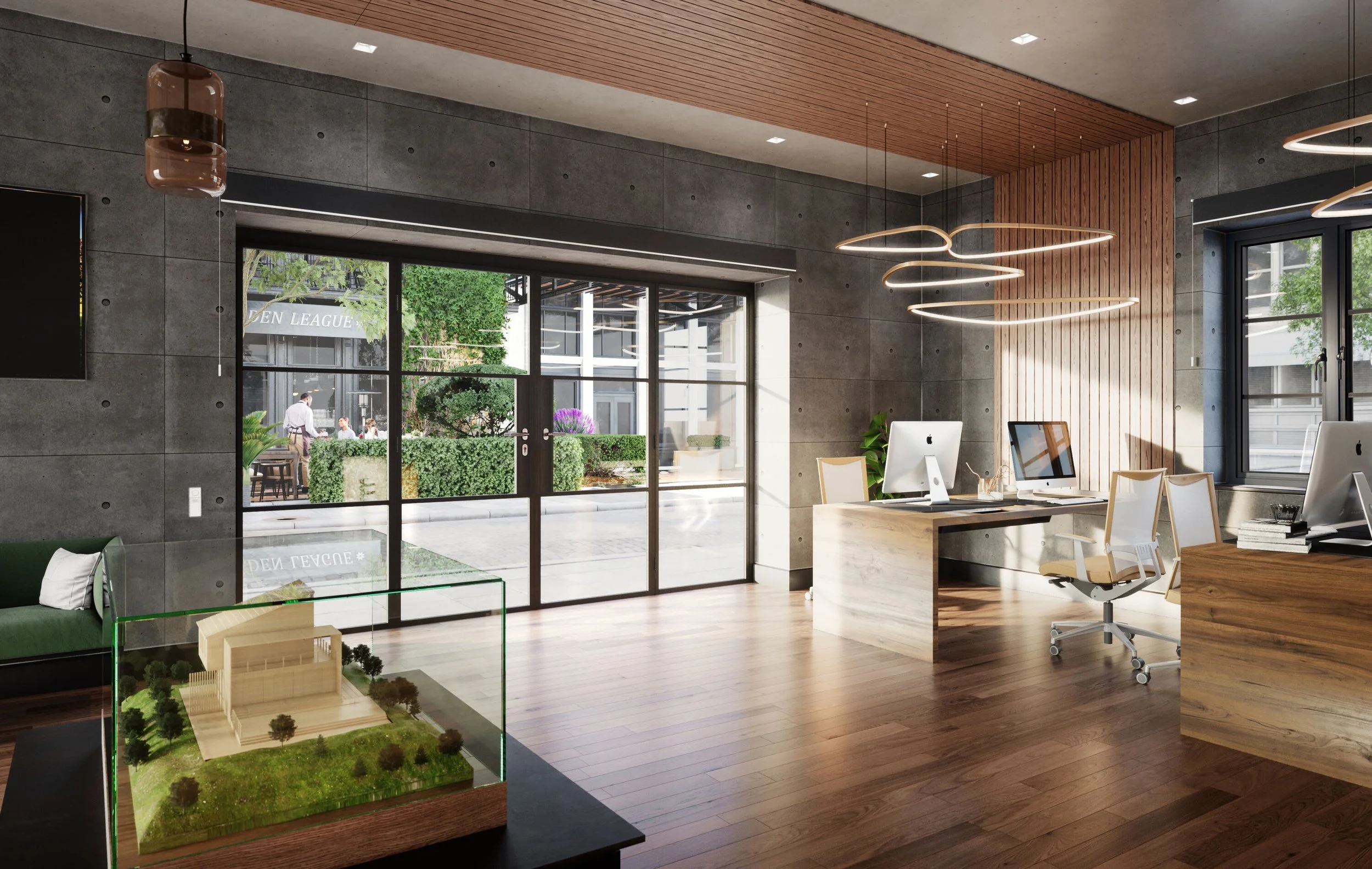 Modern office space with large windows, wooden accents, and minimalistic furniture, including desks with iMac computers and a model house on a display case.