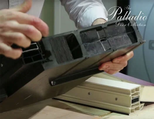 Hands holding an open black plastic cassette tape case.
