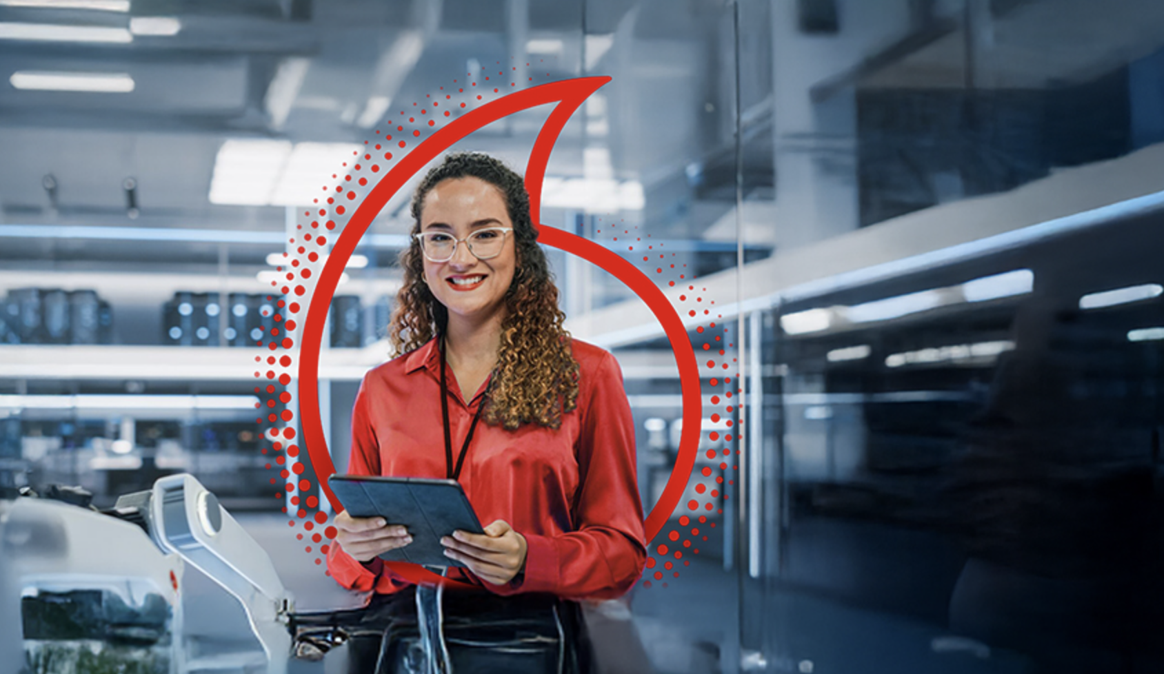 A smiling woman with glasses and curly hair wearing a red blouse standing in a modern airport, holding a tablet, with a check-in counter and airport background.