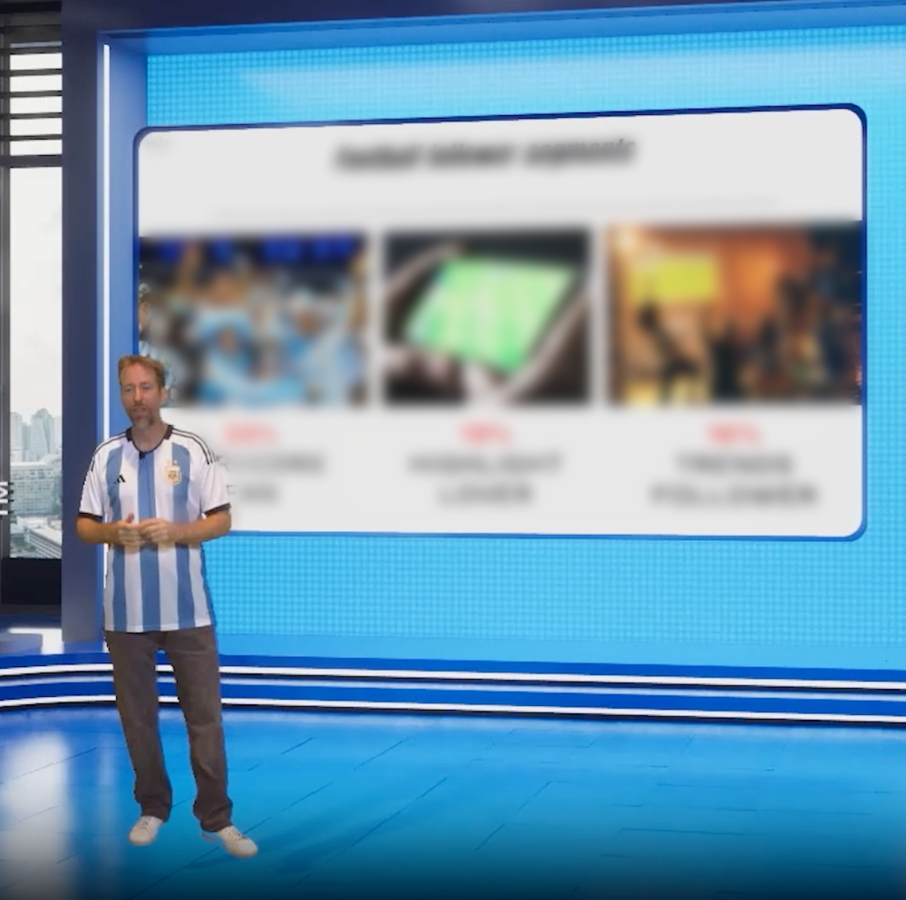 A man in an Argentina soccer jersey standing in front of a large digital screen displaying blurred images and text in a modern-style studio with city views.