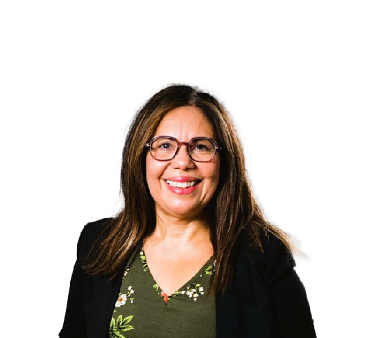 A smiling woman with shoulder-length brown hair, glasses, wearing a black blazer over a green floral blouse, against a black background.