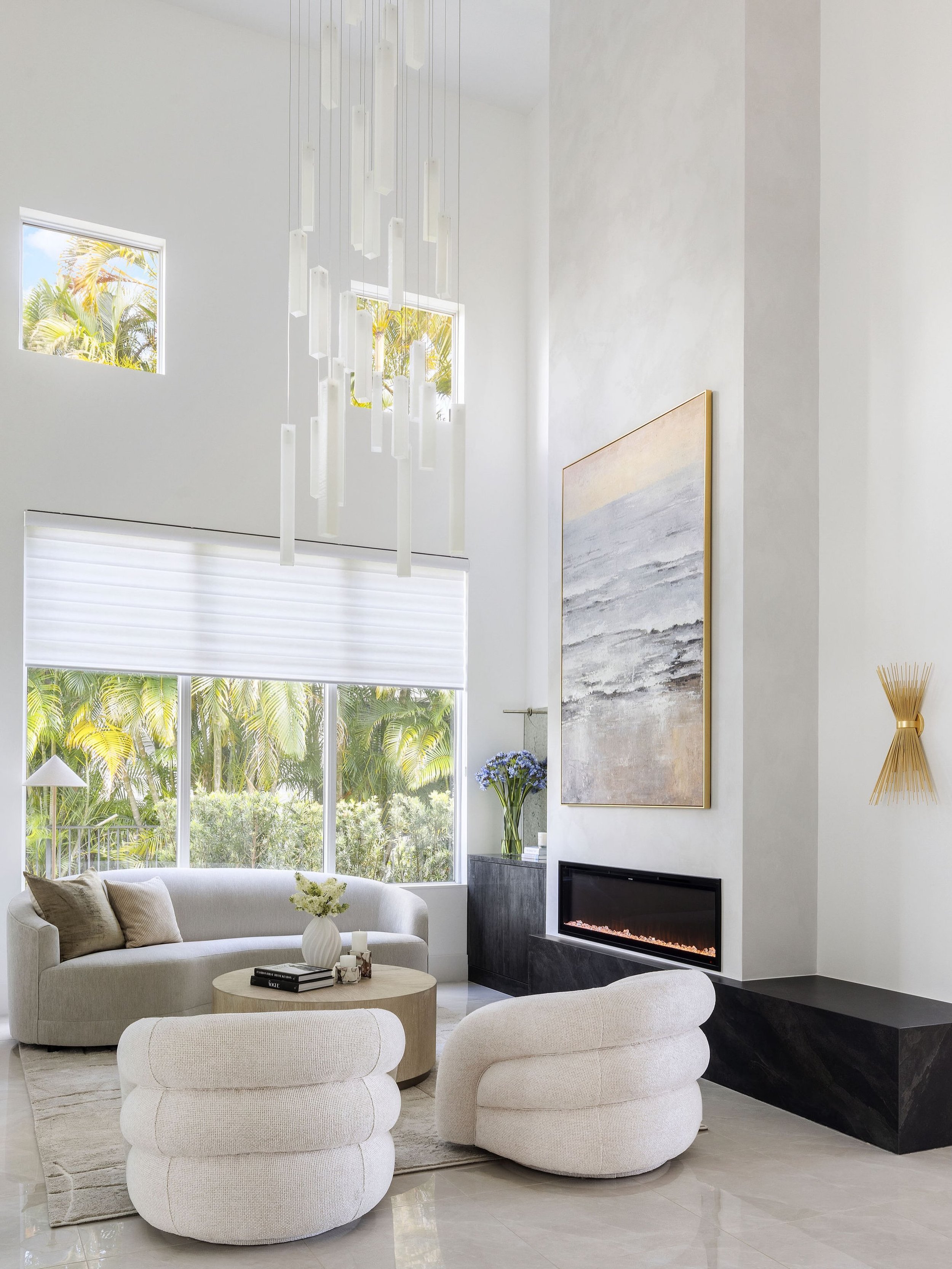 A study in scale, texture, and understated luxury.

From the sculptural lighting that draws your eye upward to the soft, curved furnishings that ground the space, every detail was thoughtfully considered to create a living room that feels both grand 