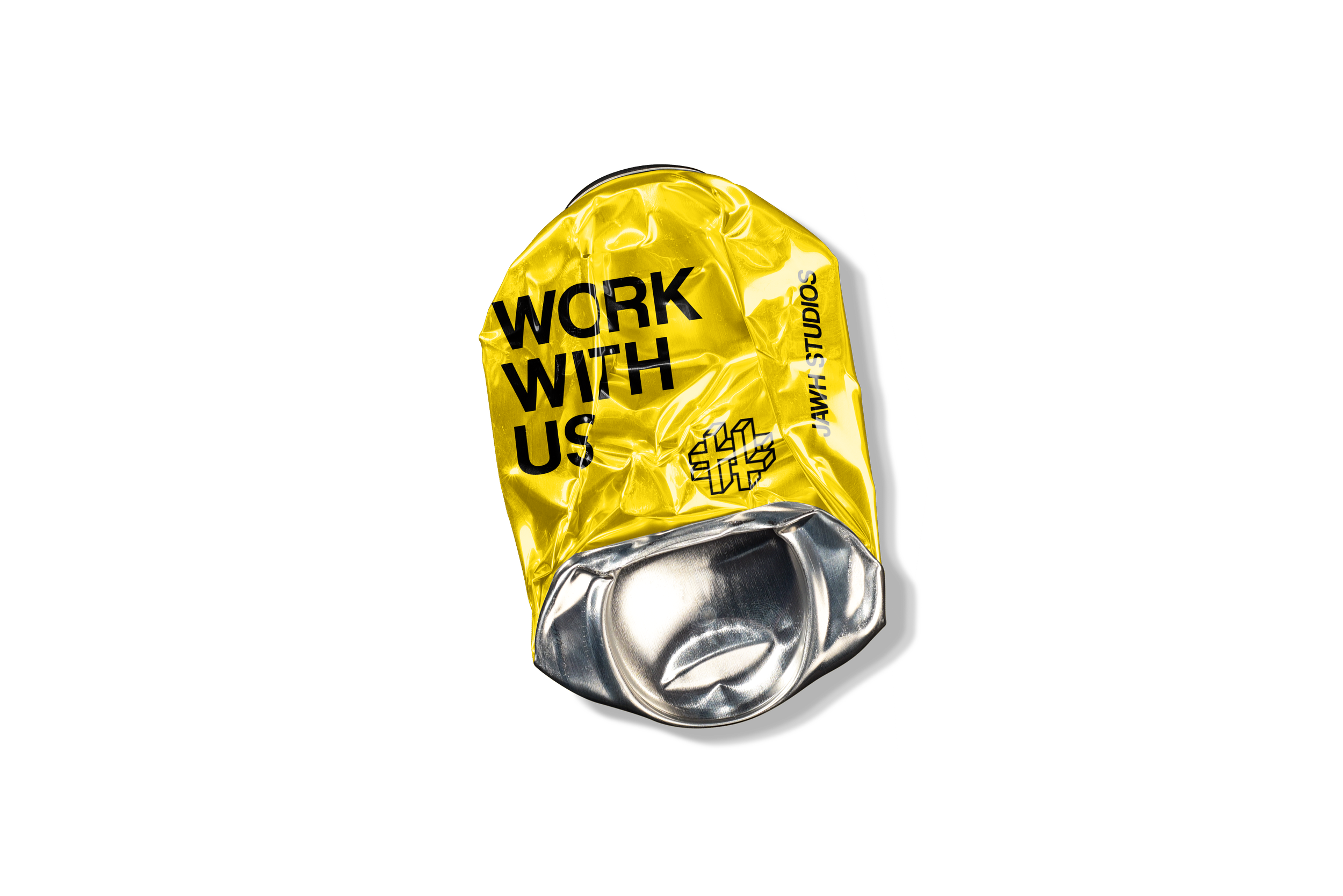 A crumpled yellow and silver beverage can with the text 'WORK WITH US' and 'JAWH STUDIOS' printed on it.