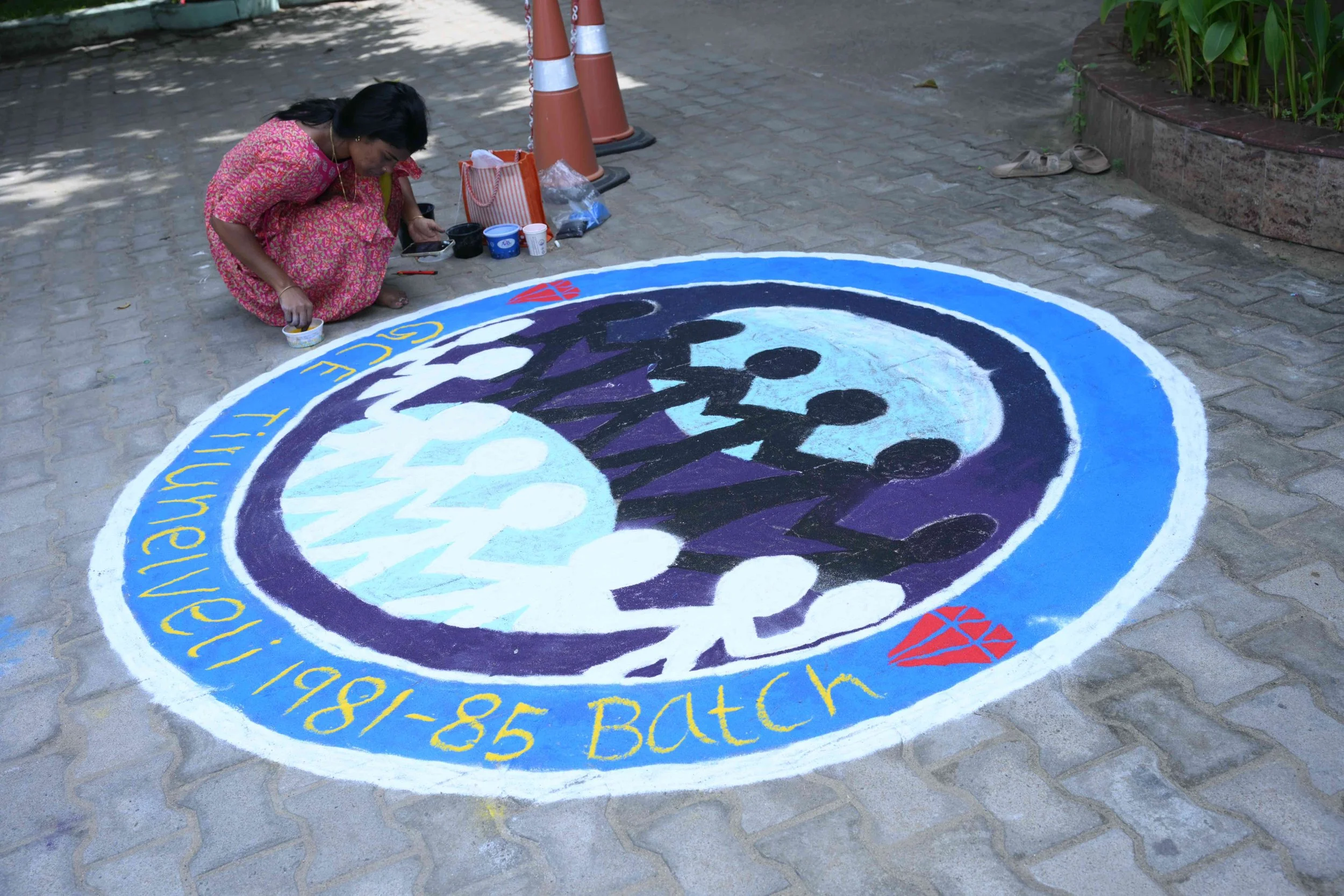 Rangoli is shaping up with this young lady's artistic talent.