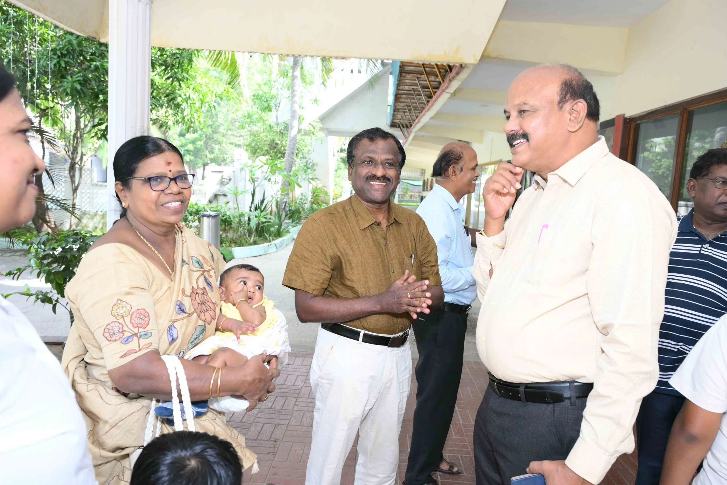 Parthasarathy arrives with his family.