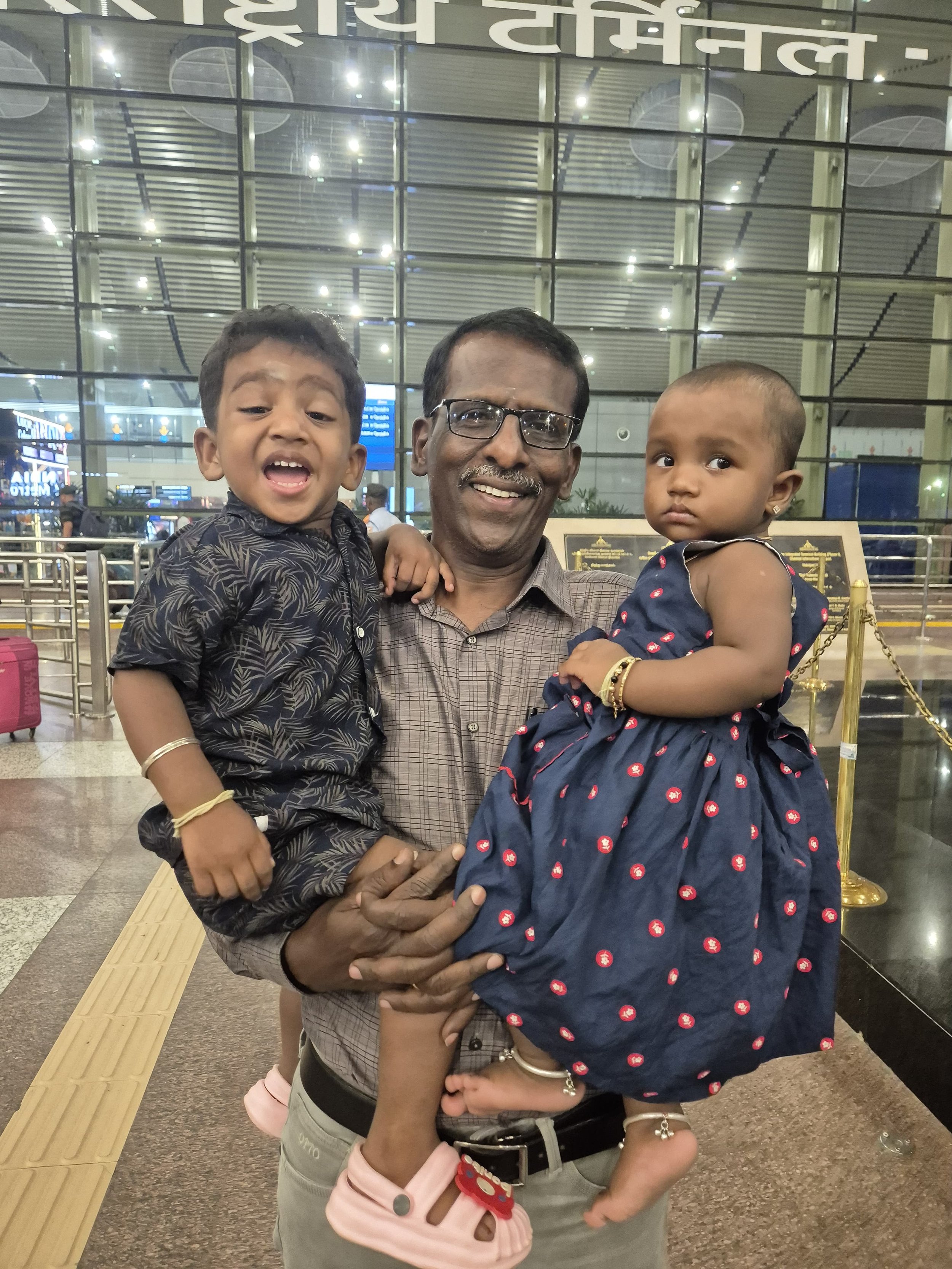 Muthukridhnan with his grandchildren at the Chennai airport.