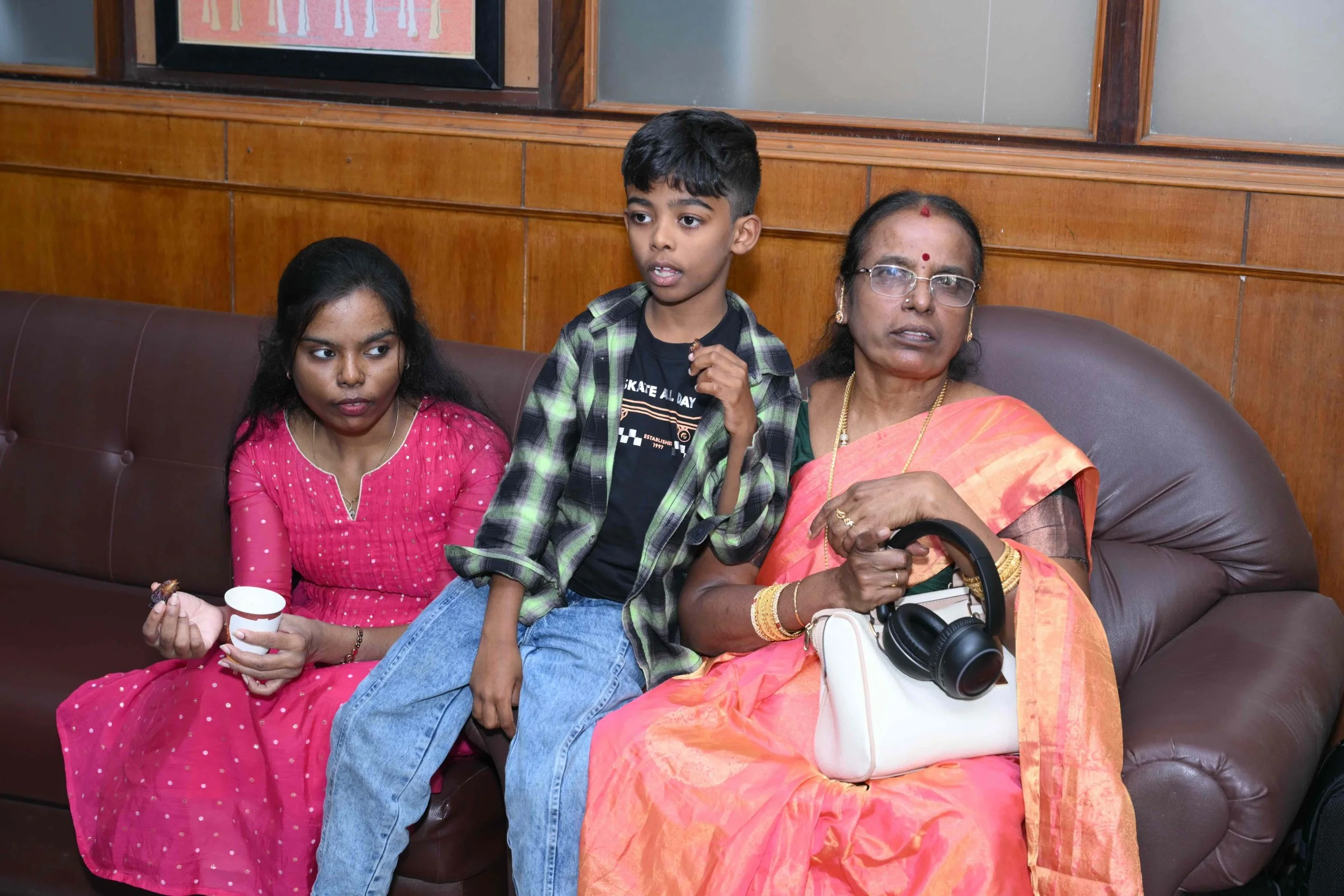Selva waits with her daughter Sharaniya and grandson Aadith Abhinav.