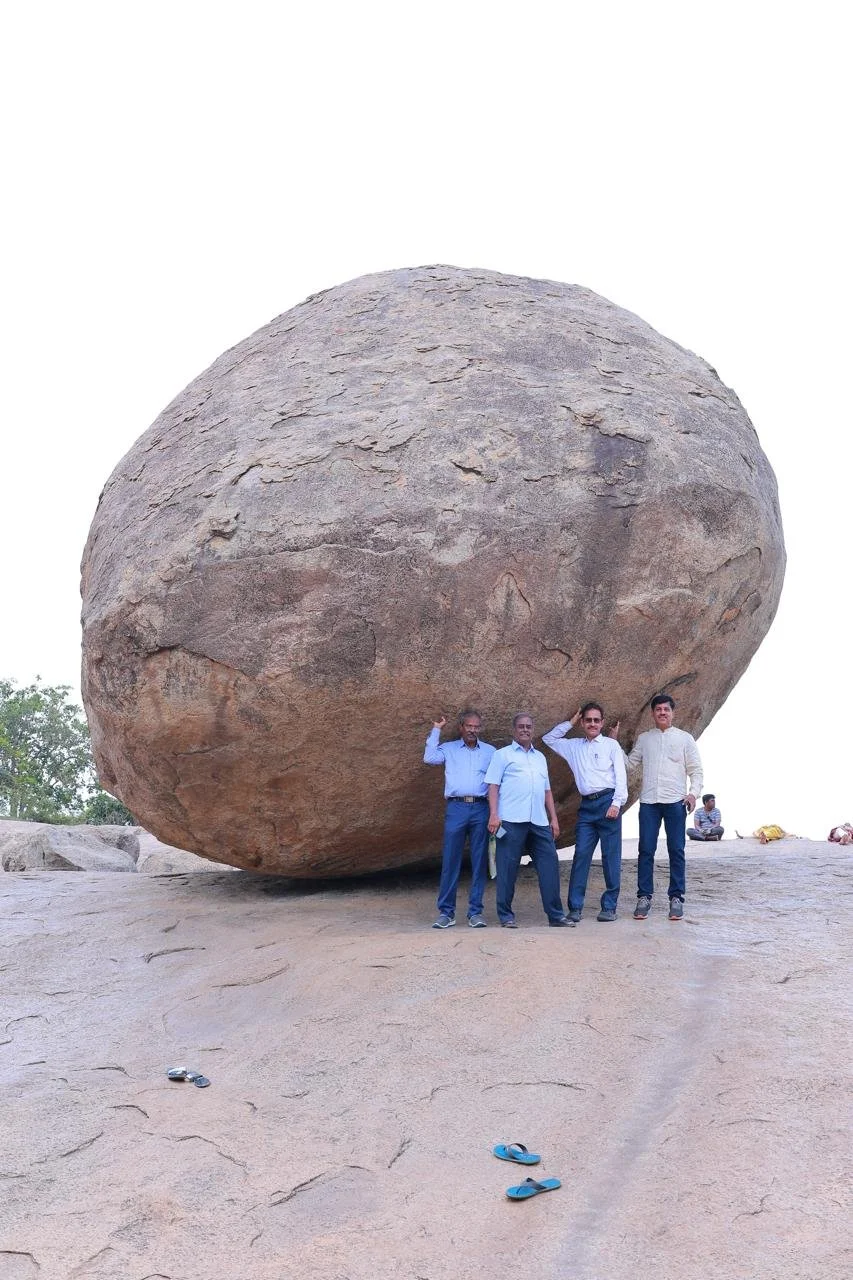 Another group of friends test if the rock is about to roll down.