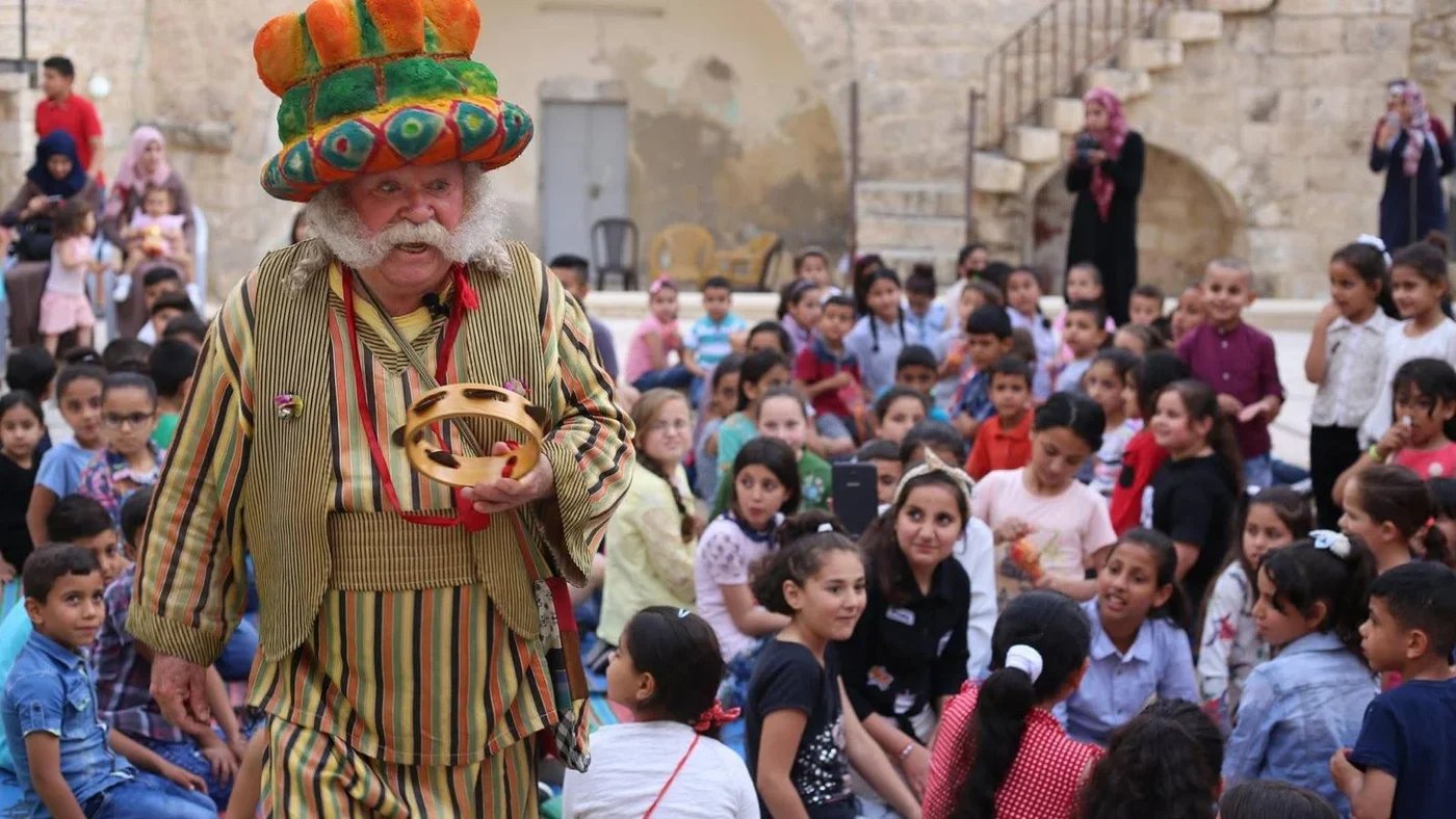 Adel Tartir performs as his character Abu Al-Ajab before an audience of children in Ramallah - Courtesy of Alaa Tartir