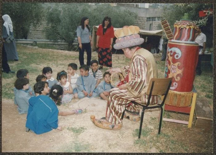 Abu al-Ajab with Kindergarten Children at (RWTC), 1995 - The Adel Tartir Collection - The Palestinian Museum