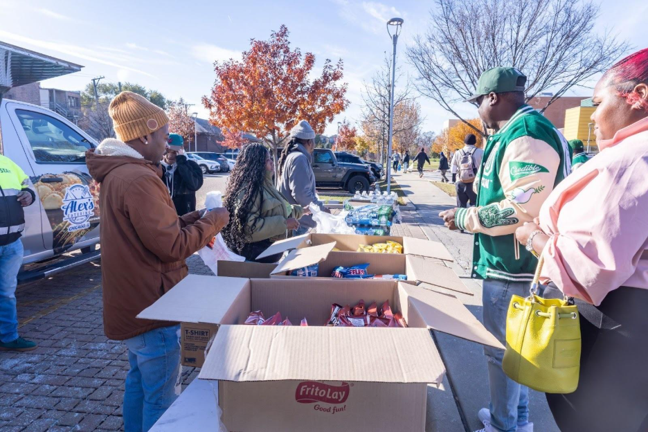   Residents line up to receive their free sandwiches, chips and drinks outside UCAN Chicago’s North Lawndale center.&nbsp;  