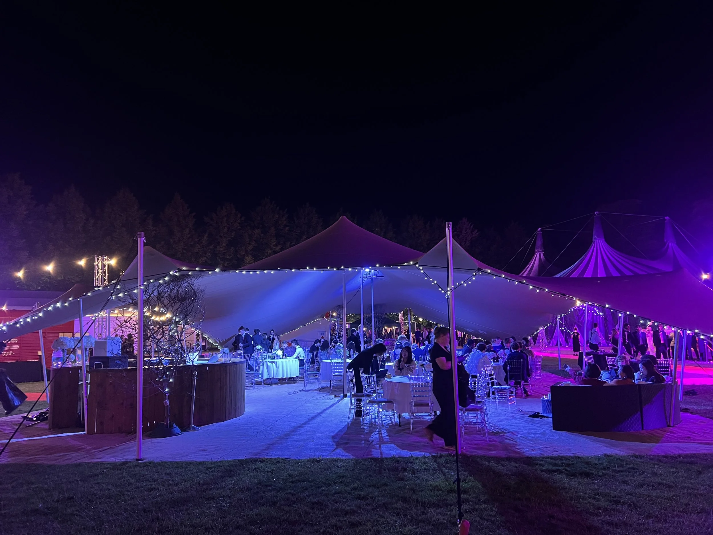 Stretch tent canopy at Trinity College Cambridge May Ball, providing an elegant outdoor event setting for guests and entertainment