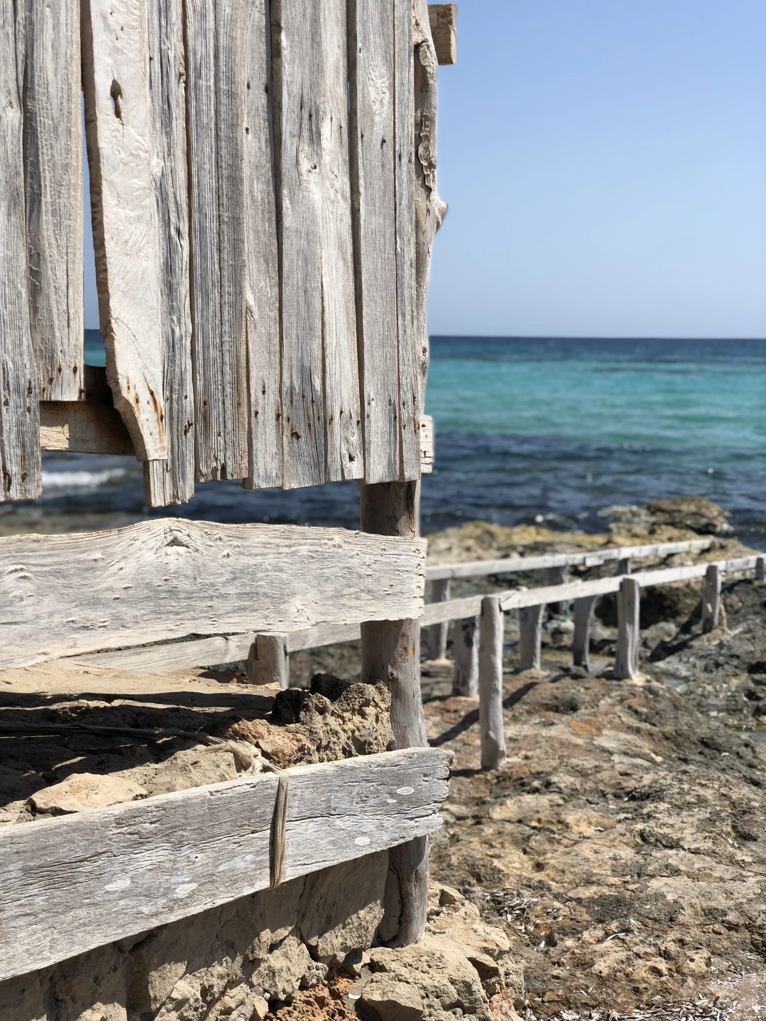Close-up of a wooden boat shelter on the beach of Formentera