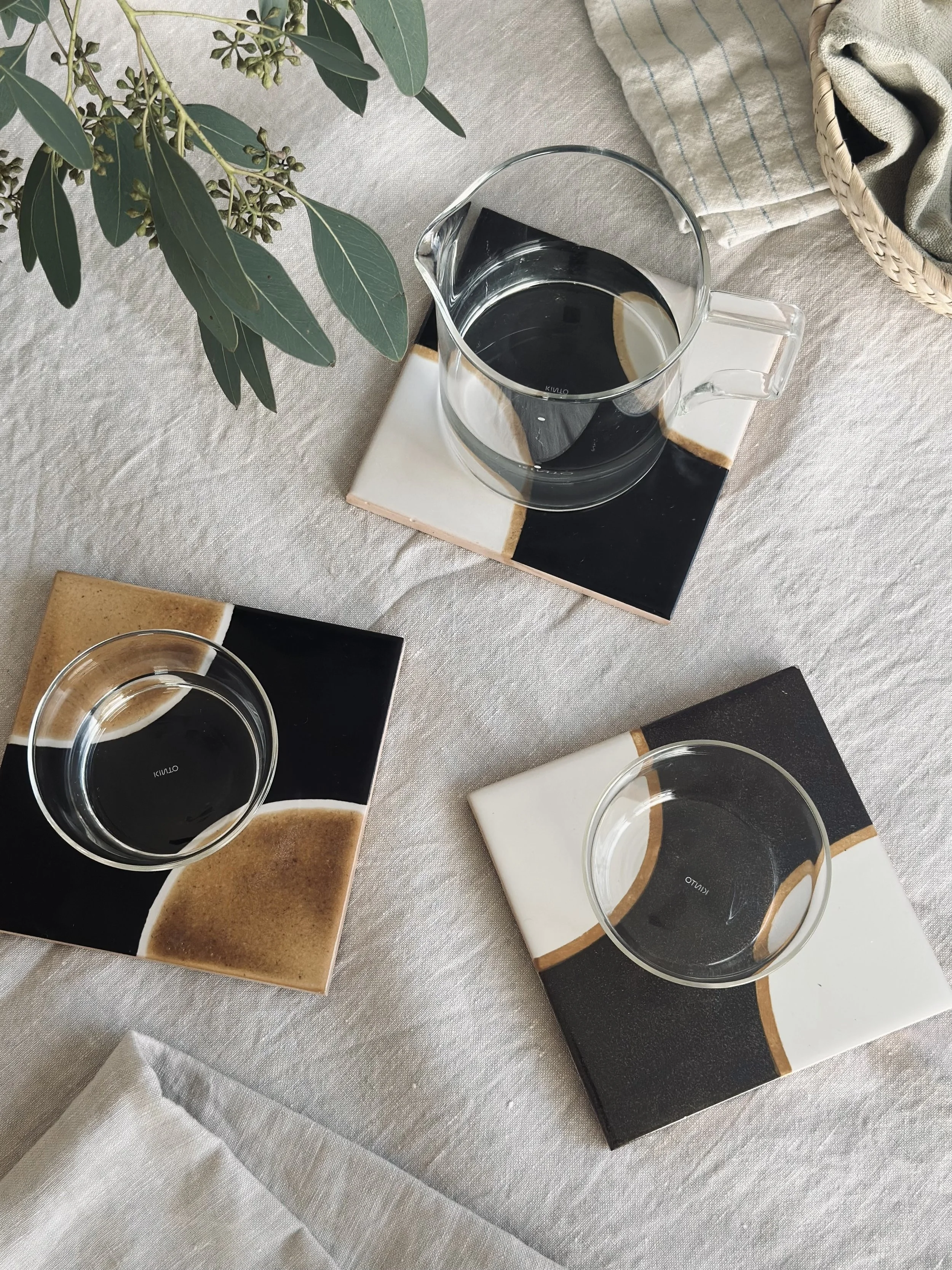 Brown and white ceramic tile coasters, hand-painted in Portugal.