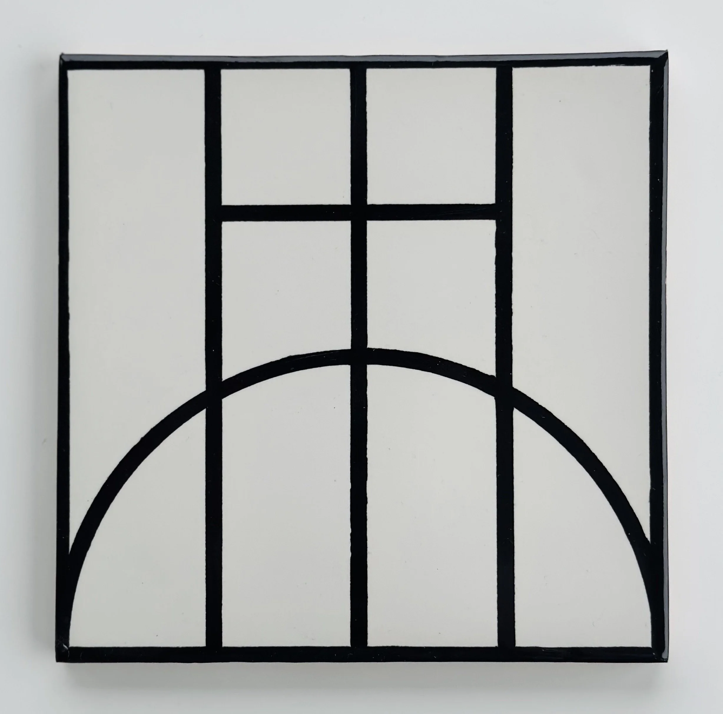 Black metal grid in a square shape with geometric patterns on a white background.