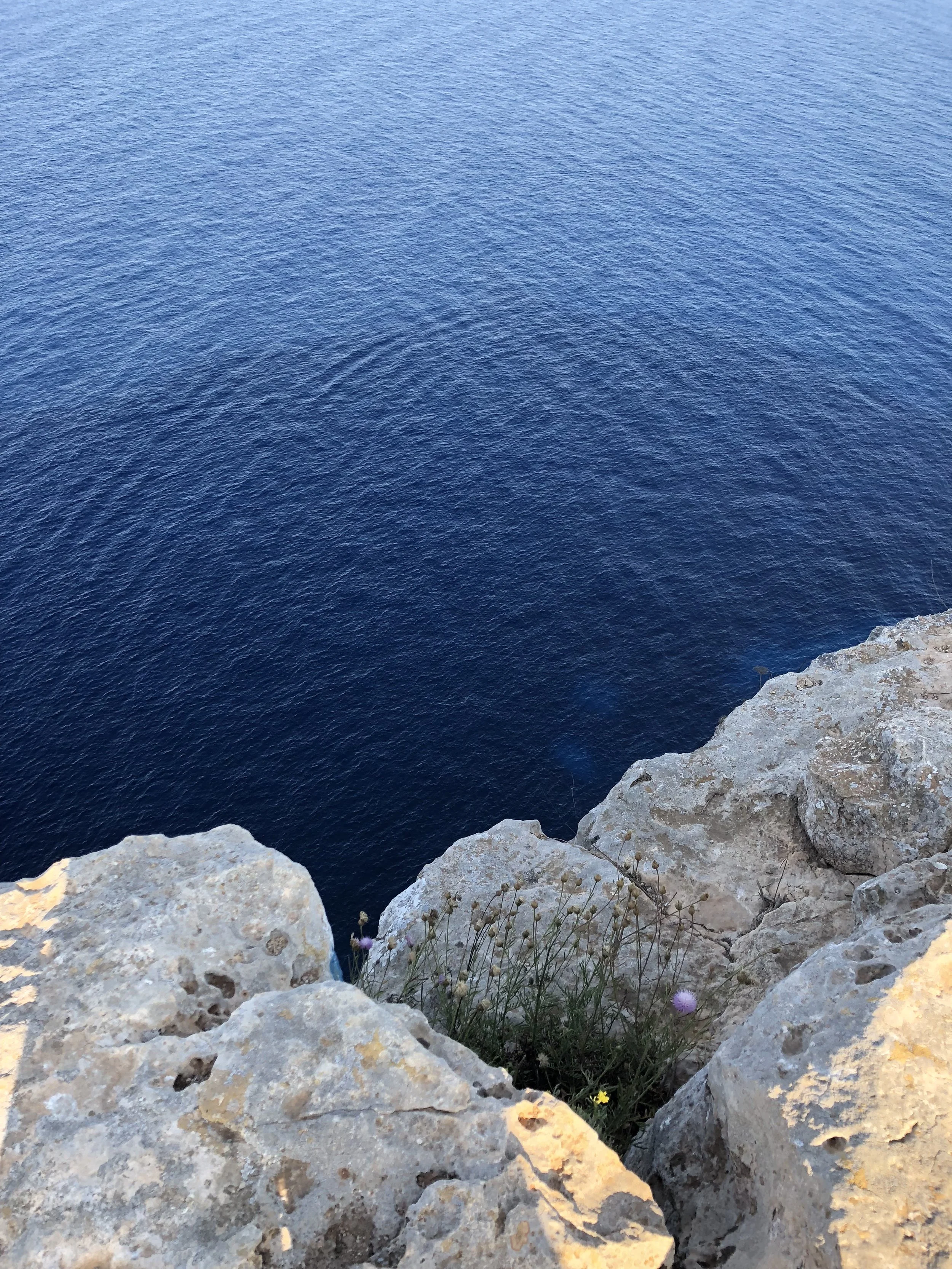 image of cliffs in Formentera with blue sea in the background
