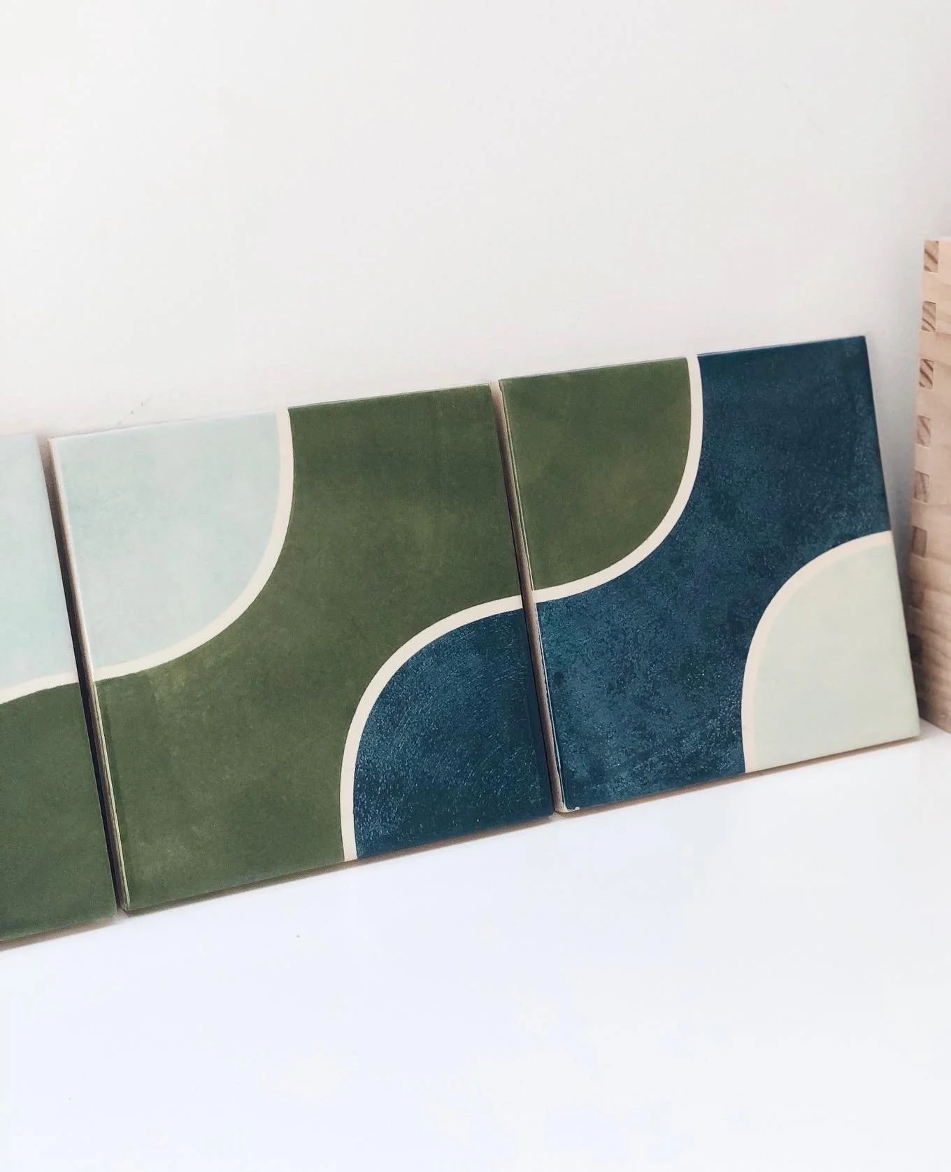 close-up of La mola tiles in green, blue and white