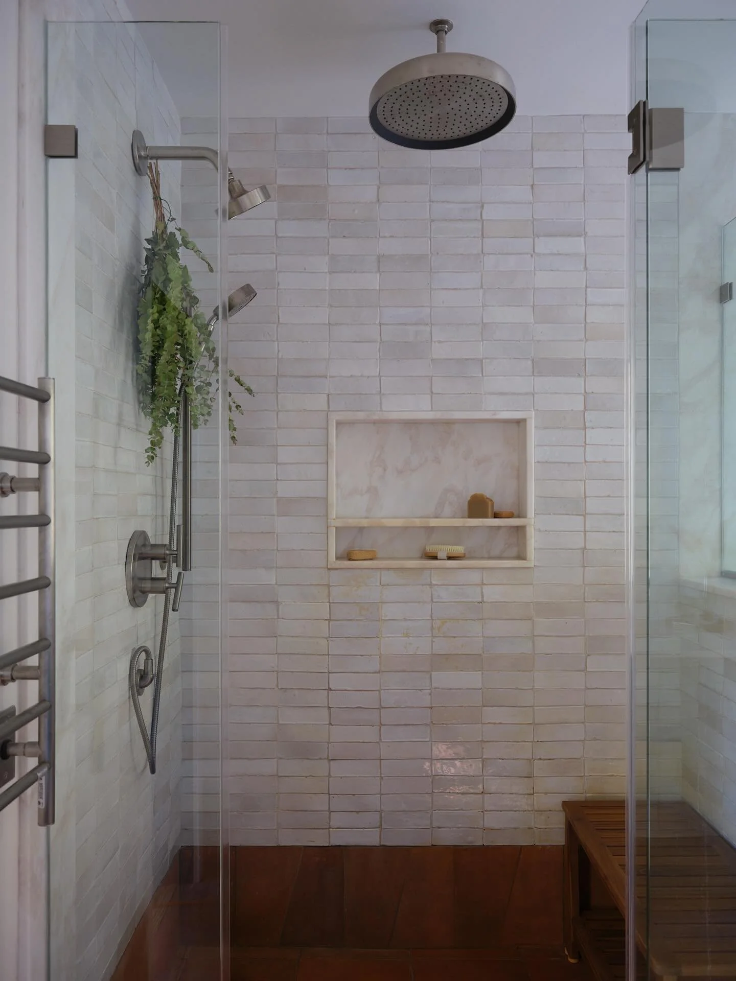 Every choice in this primary bathroom was intentional. Heated walls and a rainfall showerhead bring comfort without feeling over the top, while the soaking tub invites pause. Terracotta floors and zellige tiles bring texture and warmth, grounding the
