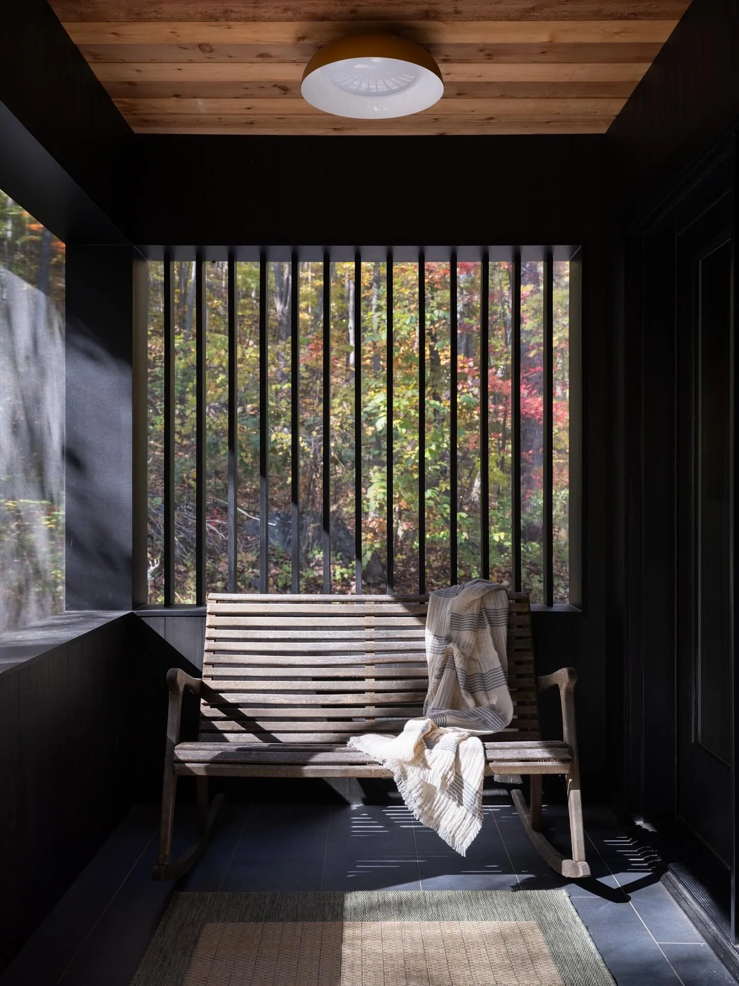 This porch addition was all about contrast done right. The original barn has history and weight to it, so we let the new structure be clean and modern. Cedar overhead for warmth, Delta Black Shou Sugi Ban for depth, black matte porcelain underfoot, a