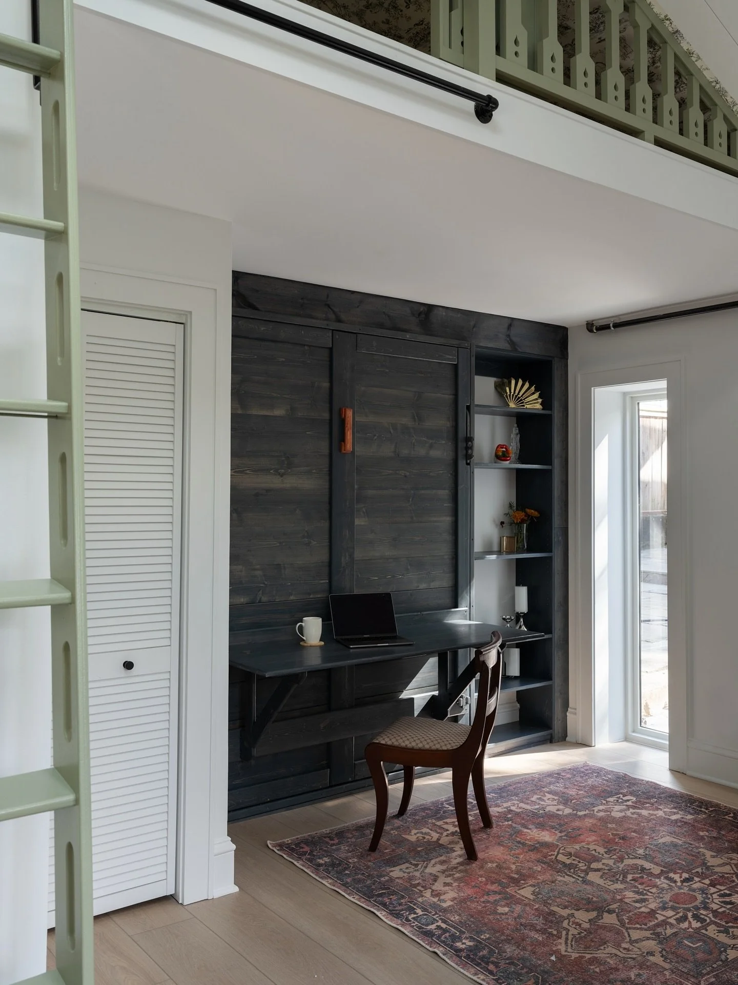 Every inch counts in this small open-concept space.

We went with a murphy bed that folds over a built-in desk so the room can switch gears depending on what&rsquo;s needed. Extra bed for visiting family, a workspace, or a spot for little ones to dra