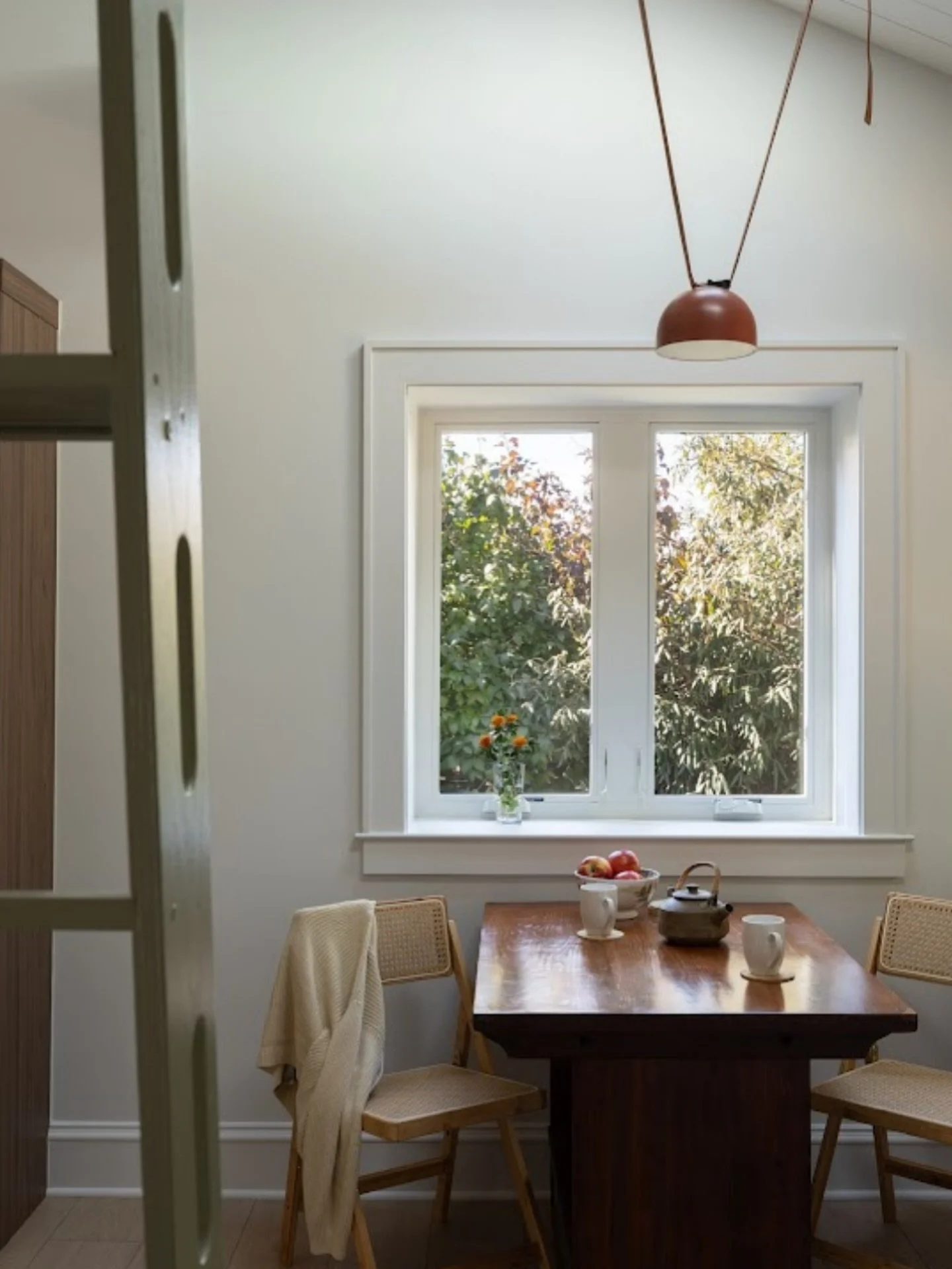This is our favorite image from the whole project.

You&rsquo;re looking at the dinette from behind the loft ladder, which says a lot about how tight this footprint really is. Every inch had to count, especially wall space.

The skylight was a big mo