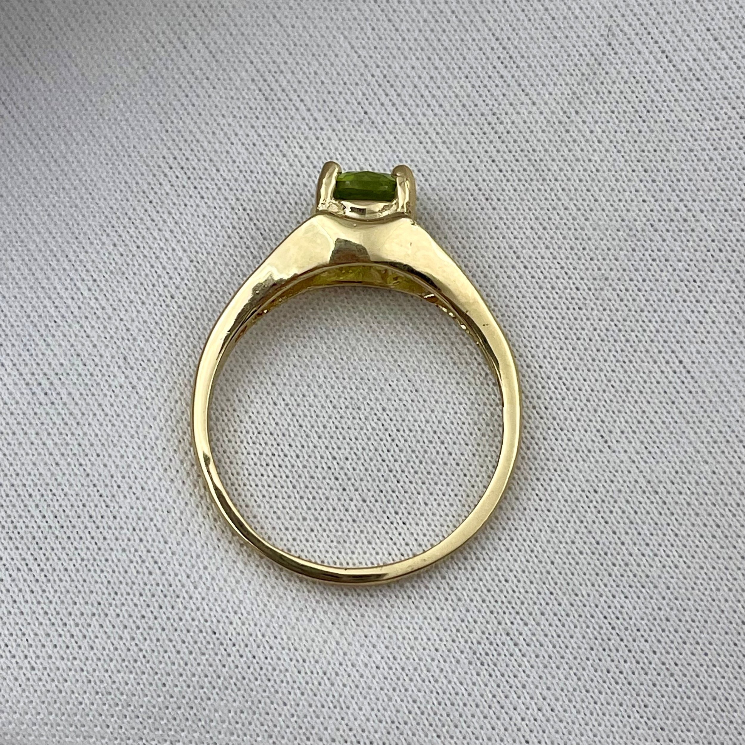 top down gallery view of 14k Yellow Gold 6mm Round Peridot With Filigree Shoulders Ladies Ring with white background