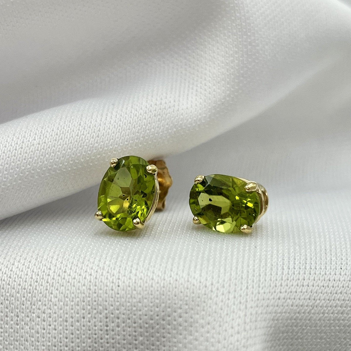 close up white background Peridot Stud Earrings 8x6mm Oval Cut 14k Yellow Gold